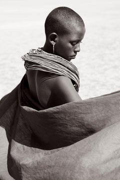 A young Rendille woman in traditional jewelry and attire in the desert of Kenya