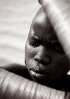 A young Suri boy in a black and white fashion-inspired portrait