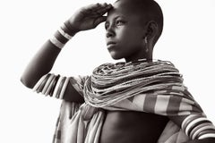 A young woman looks out over the Northern Kenyan desert, her ancestral home