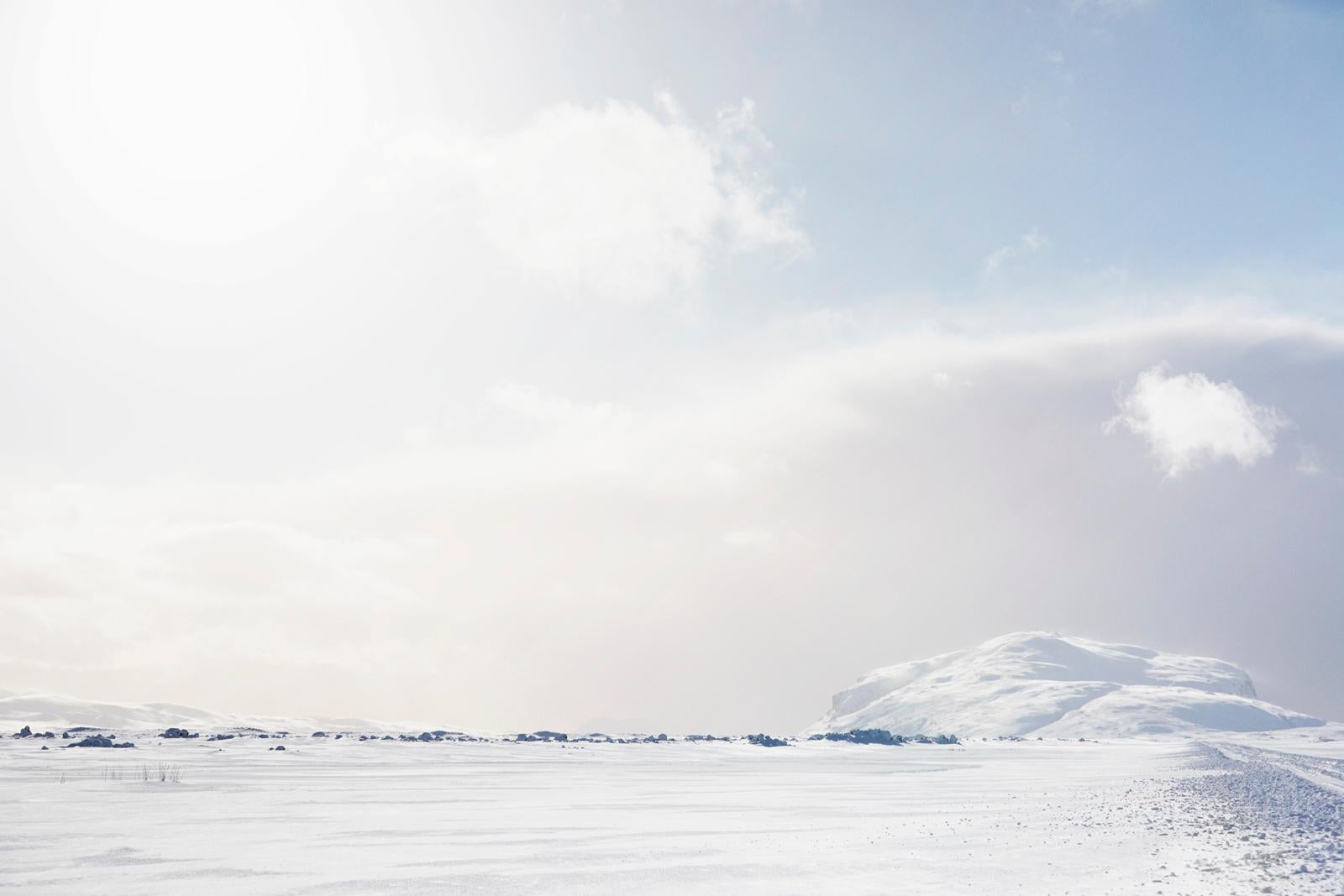 Drew Doggett Landscape Photograph - An epic, dream-like snowy tundra in Iceland hit by the sun