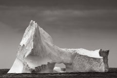 An iceberg with organic, angular features in this surreal black and white photo
