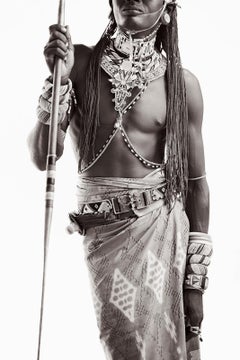 Black and white portrait of the front of a young Samburu warrior holding a spear