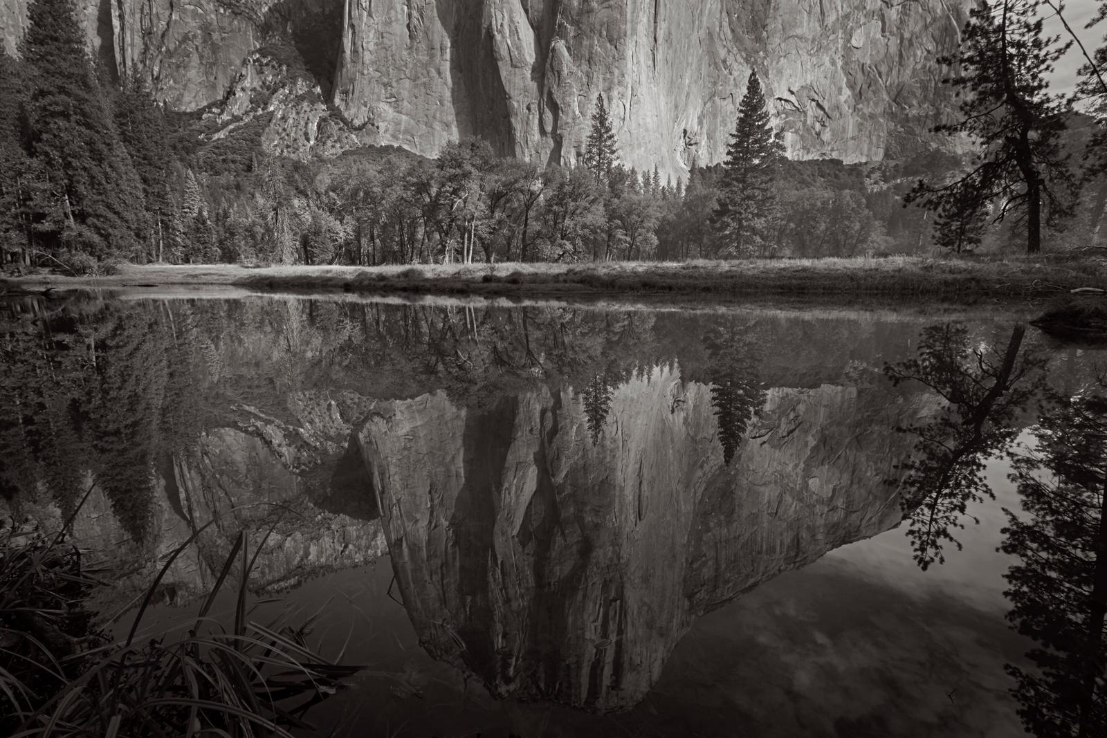 El Capitan reflected in a still pool of water - Photograph by Drew Doggett