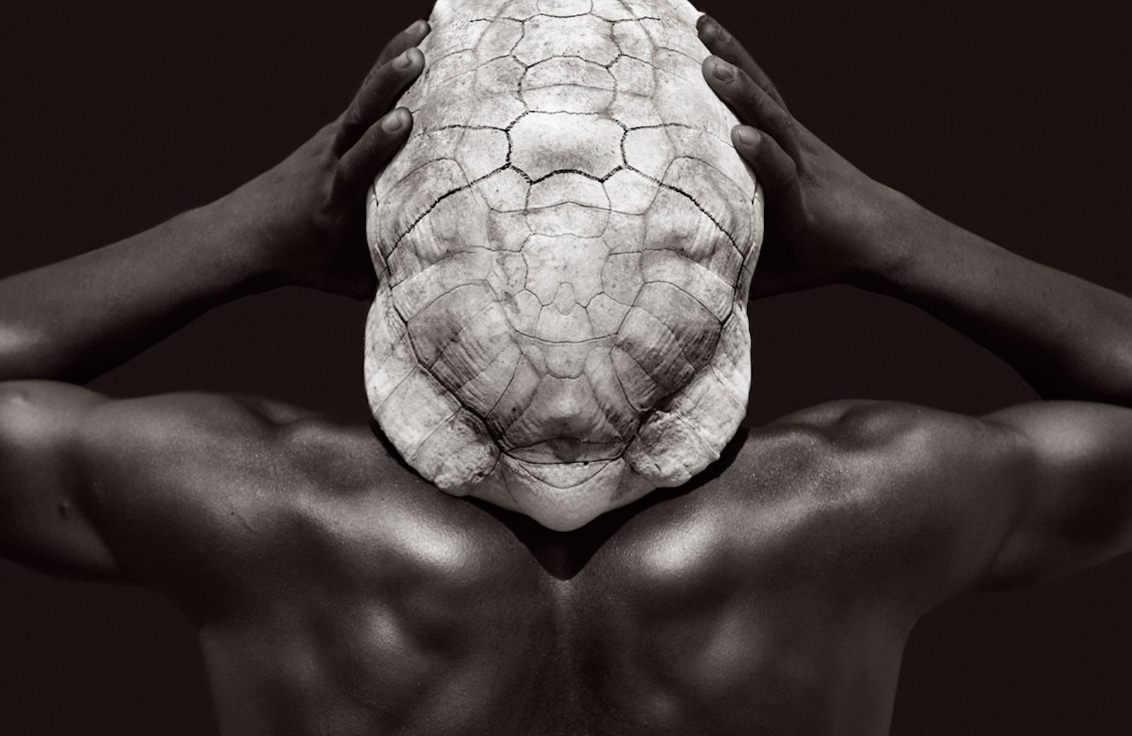Fashion-inspired image of a Karo man in Ethiopia with a tortoise shell - Photograph by Drew Doggett