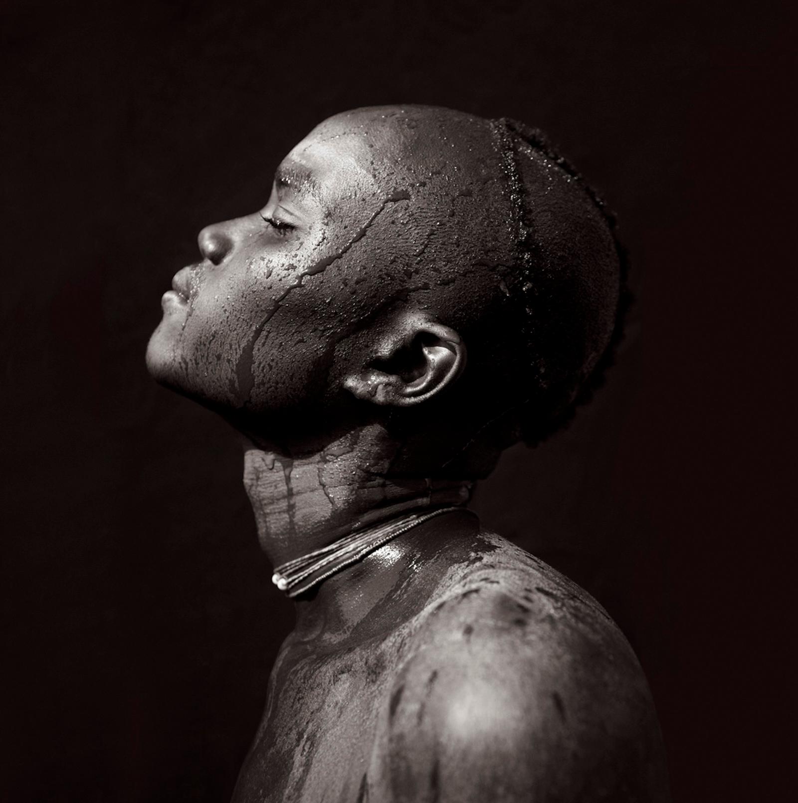 Fashion-inspired portrait of a Suri warrior against a dark backdrop