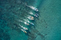 Inspiring portrait of longboarders racing to catch the same wave