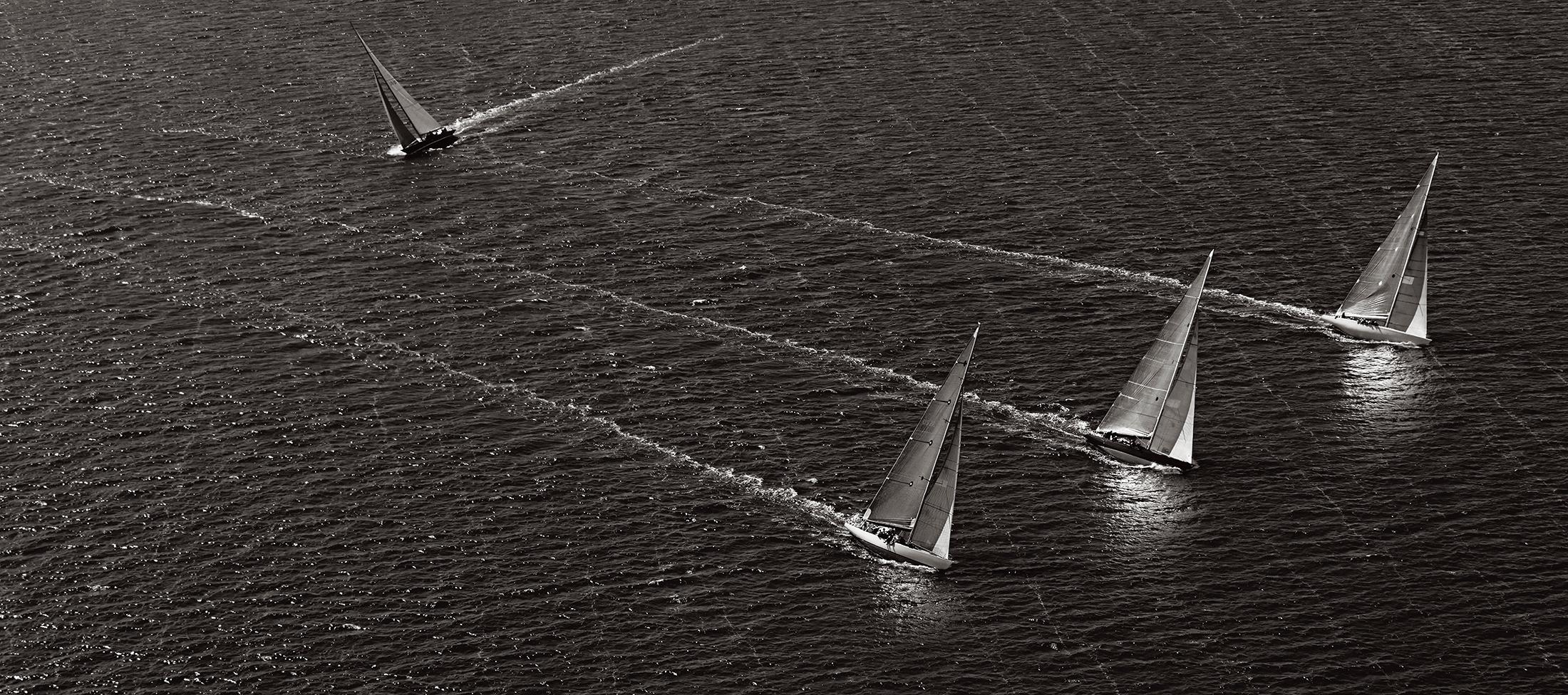 Drew Doggett Black and White Photograph - The wake of these yachts creates an incredible crisp white line of foam