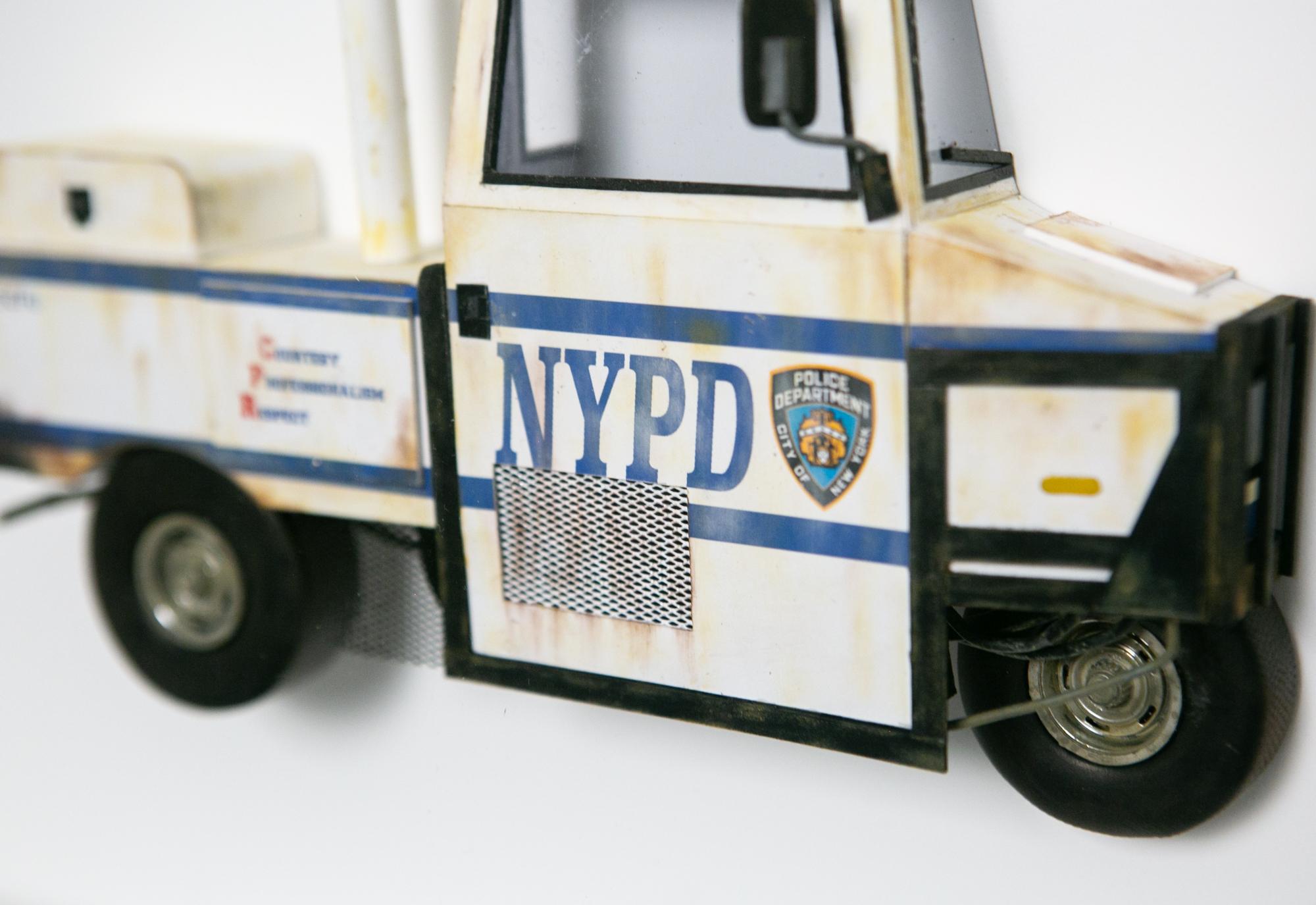 Original NYPD interceptor sculpture made of archival paper, dry pigments, enamel, wood, clay, wire, plastic, and inkjet print by Drew Leshko measuring 16