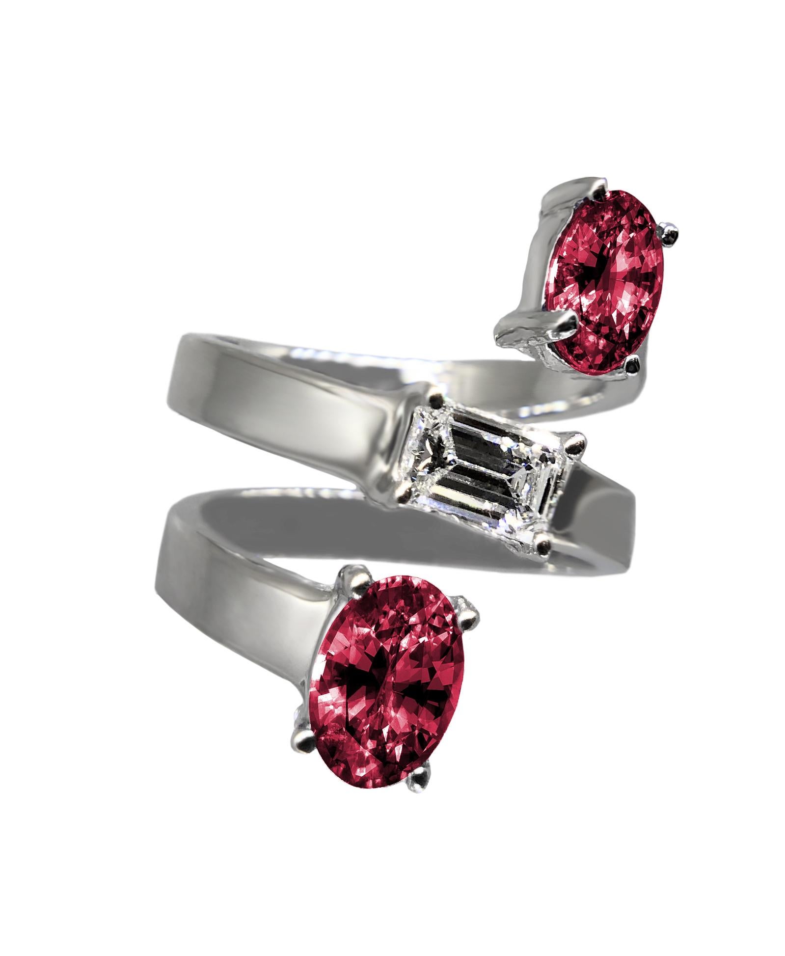 An exceptional and impressive ring by the American high jewelry designer, Drew Pietrafesa. Mounted in 18K white gold, a VS quality emerald-cut diamond is joined by two red oval rhodolite garnet gemstones. This snake ring will wrap your finger in