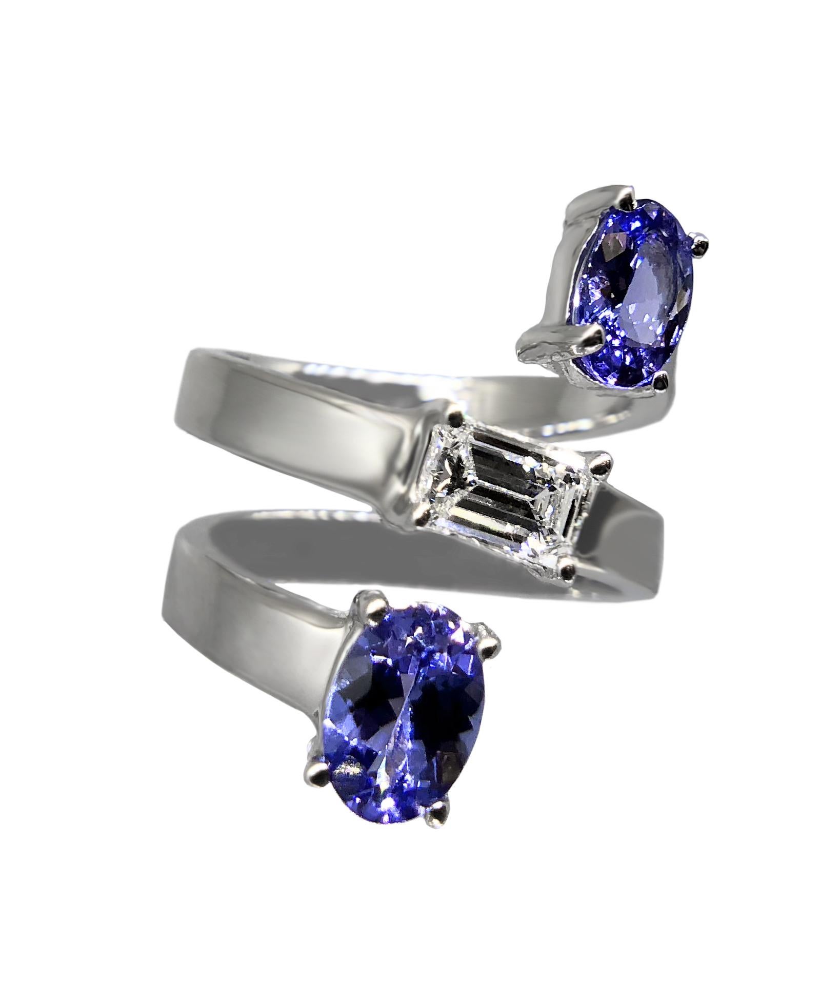 An exceptional and impressive ring by the American high jewelry designer, Drew Pietrafesa. Mounted in 18K white gold, a VS quality emerald-cut diamond is joined by two blue oval tanzanite gemstones. This snake ring will wrap your finger in unrivaled