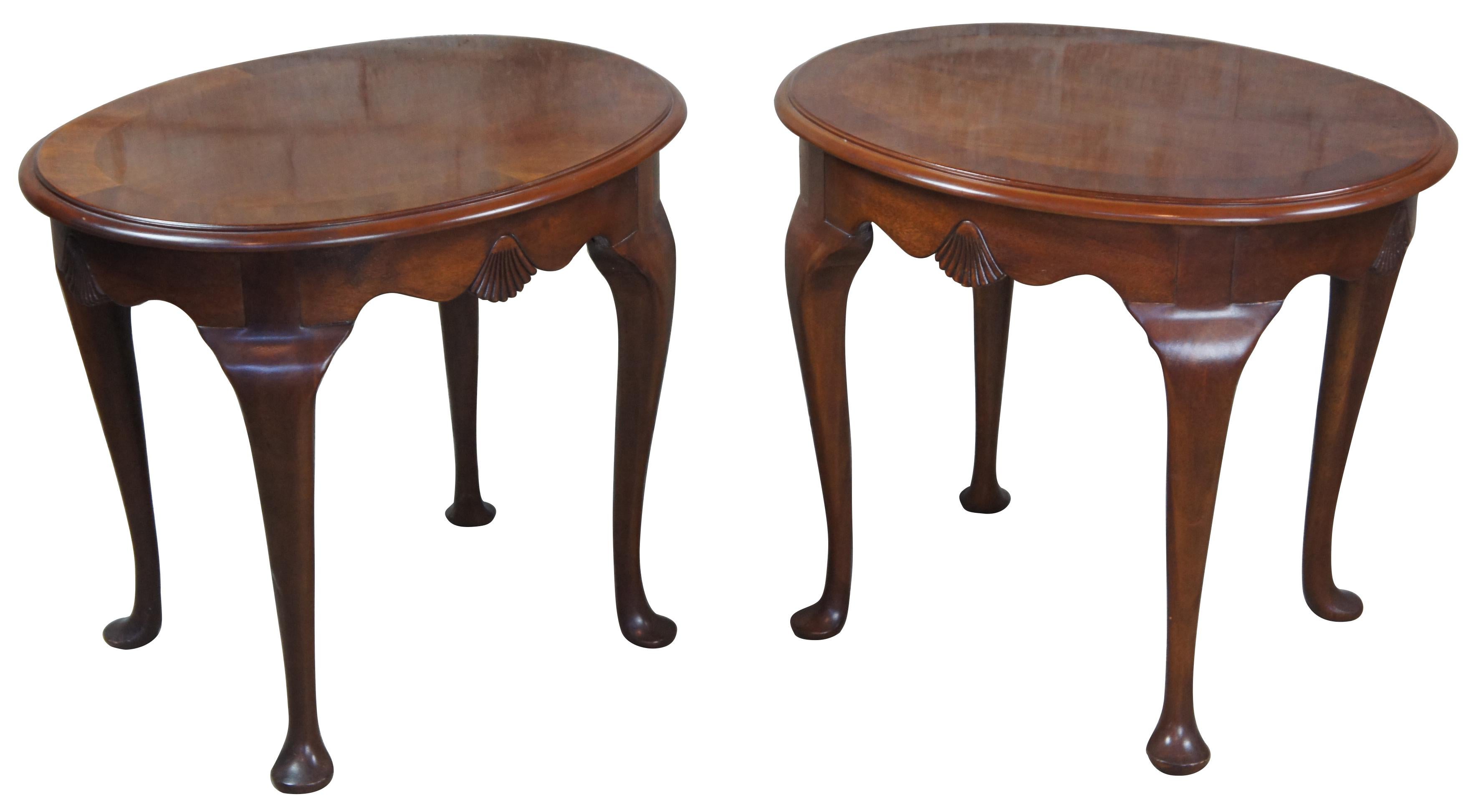 Pair of Drexel 18th century collection oval side, end or accent tables, #138-306-3, circa 1988. Features a banded top, scalloped apron and cabriole legs leading to pad feet.
 