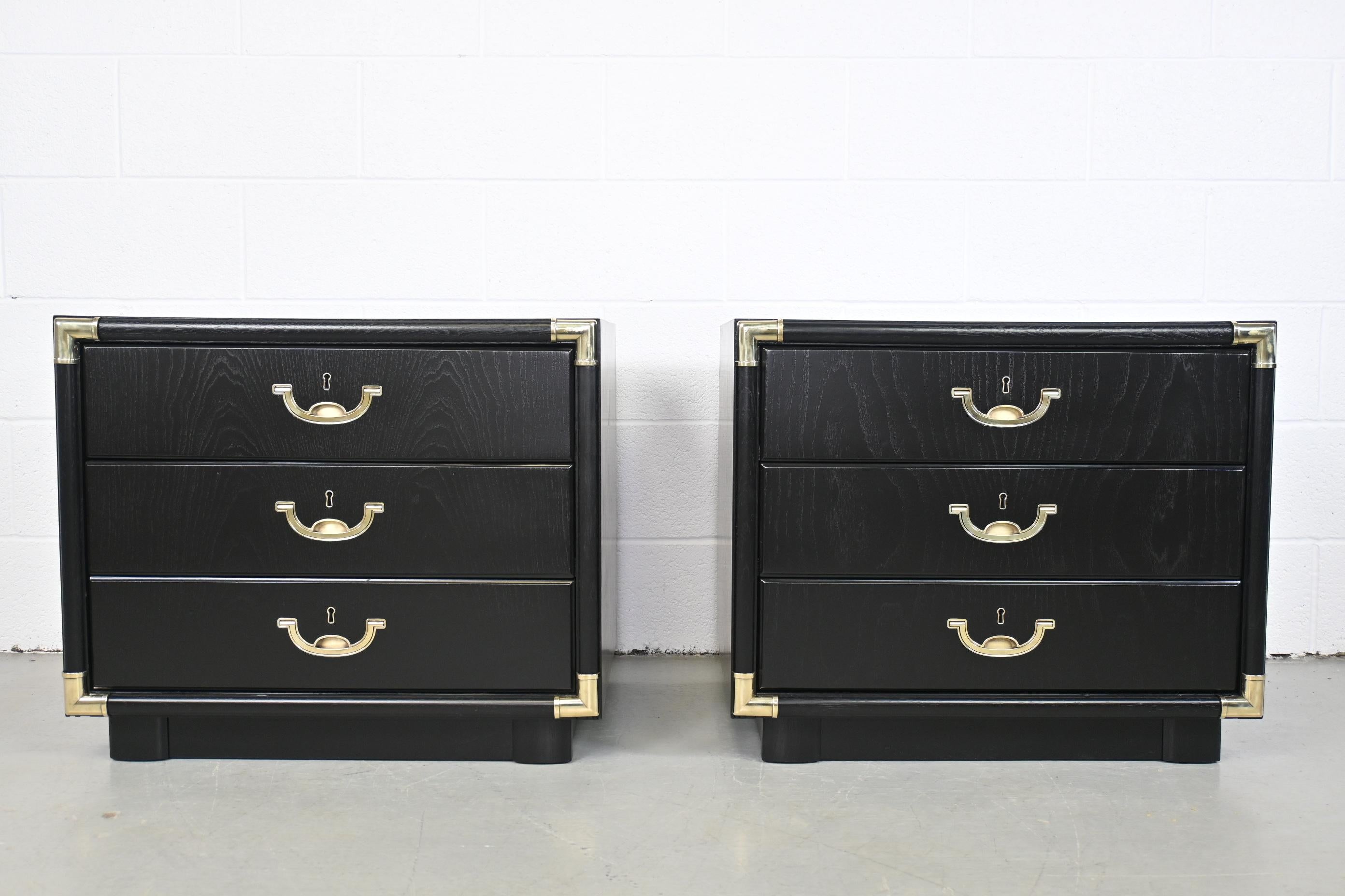 Drexel Accolade Campaign Style Black Lacquered Three Drawer Pair of Nightstands or End Tables

Drexel, USA, 1970s

Measures: 26.5 Wide x 18 Deep x 22.5 High

Mid Century Campaign style black lacquered three drawer nightstands with brass