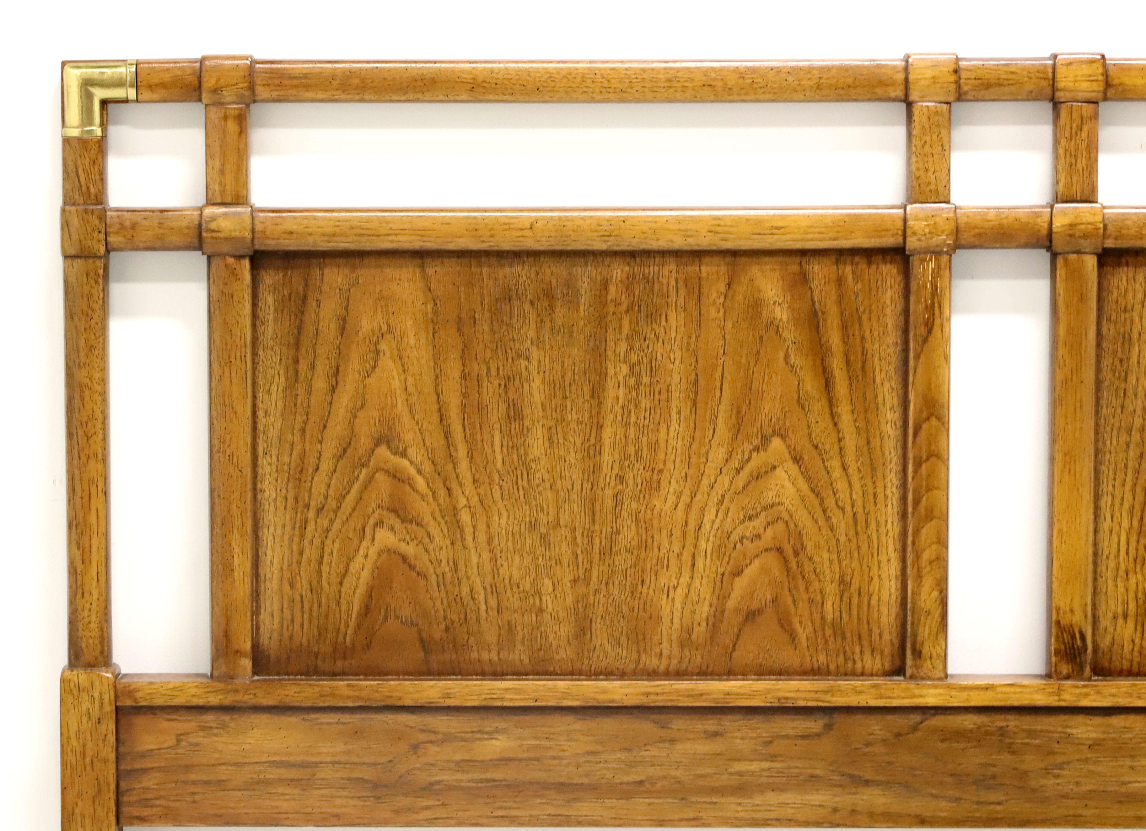 A Campaign style queen size headboard by Drexel Heritage, from their Accolade Collection. Pecan with decorative brass corner accents. Made in North Carolina, USA, circa 1985. 

Style #: 904-562-2

Measures: 60.25 W 1.75 D 43.25