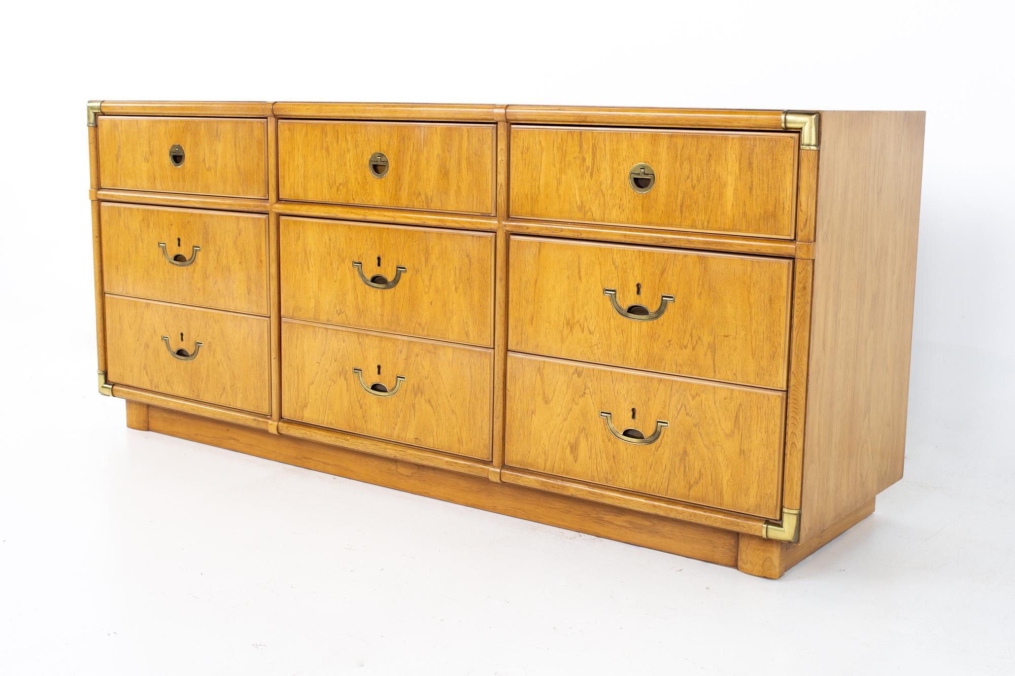 Drexel Campaign mid century walnut and brass 9 drawer lowboy dresser.
Dresser measures: 68 wide x 19 deep x 29.5 inches high

All pieces of furniture can be had in what we call restored vintage condition. That means the piece is restored upon
