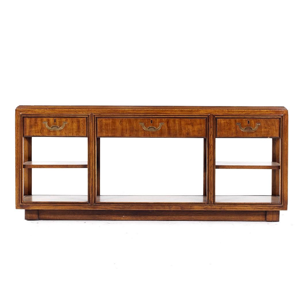 Drexel Campaign Pecan and Brass Console Sofa Table

This console table measures: 59.25 wide x 14.75 deep x 25.5 inches high

All pieces of furniture can be had in what we call restored vintage condition. That means the piece is restored upon