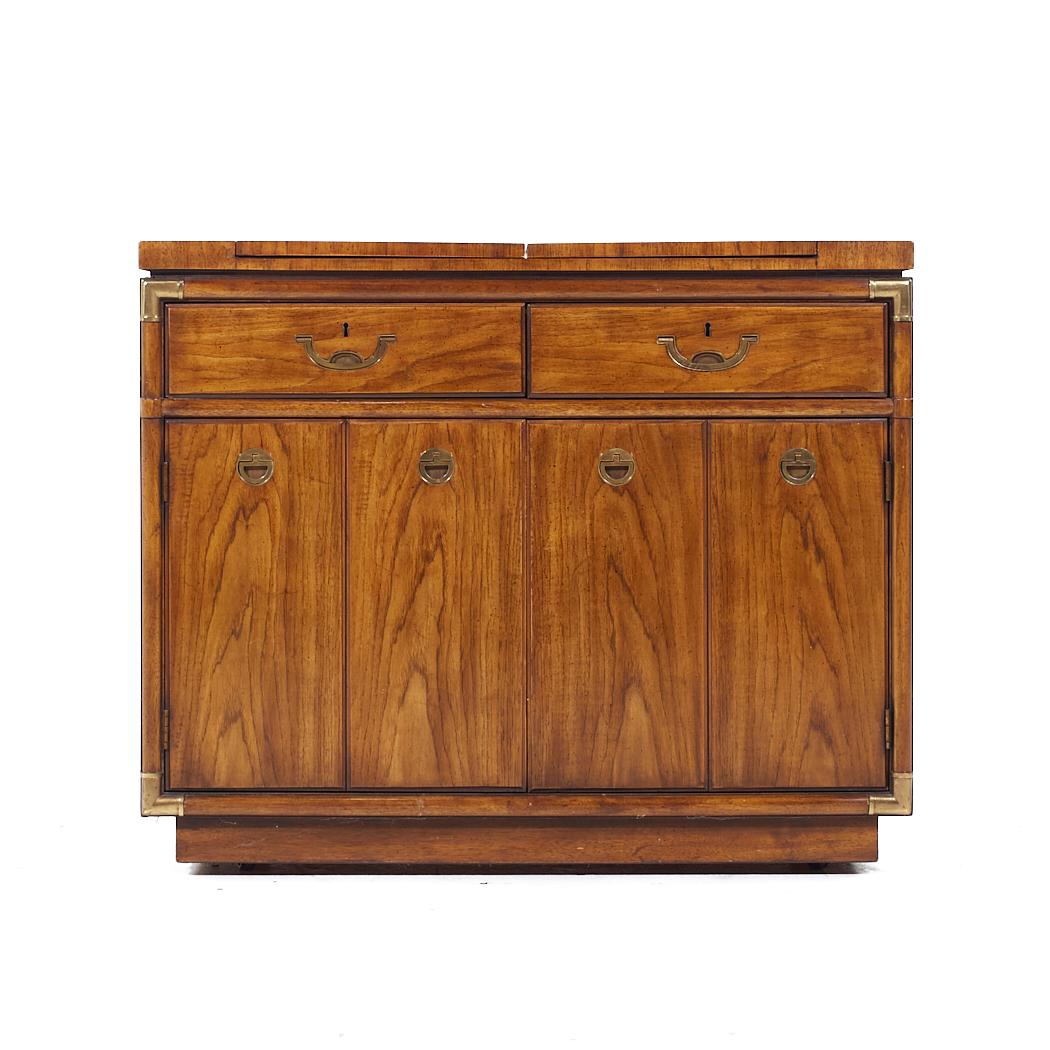 Drexel Campaign Pecan and Brass Rolling Flip Top Buffet

This buffet measures: 40 wide x 19 deep x 33 inches high

All pieces of furniture can be had in what we call restored vintage condition. That means the piece is restored upon purchase so it’s