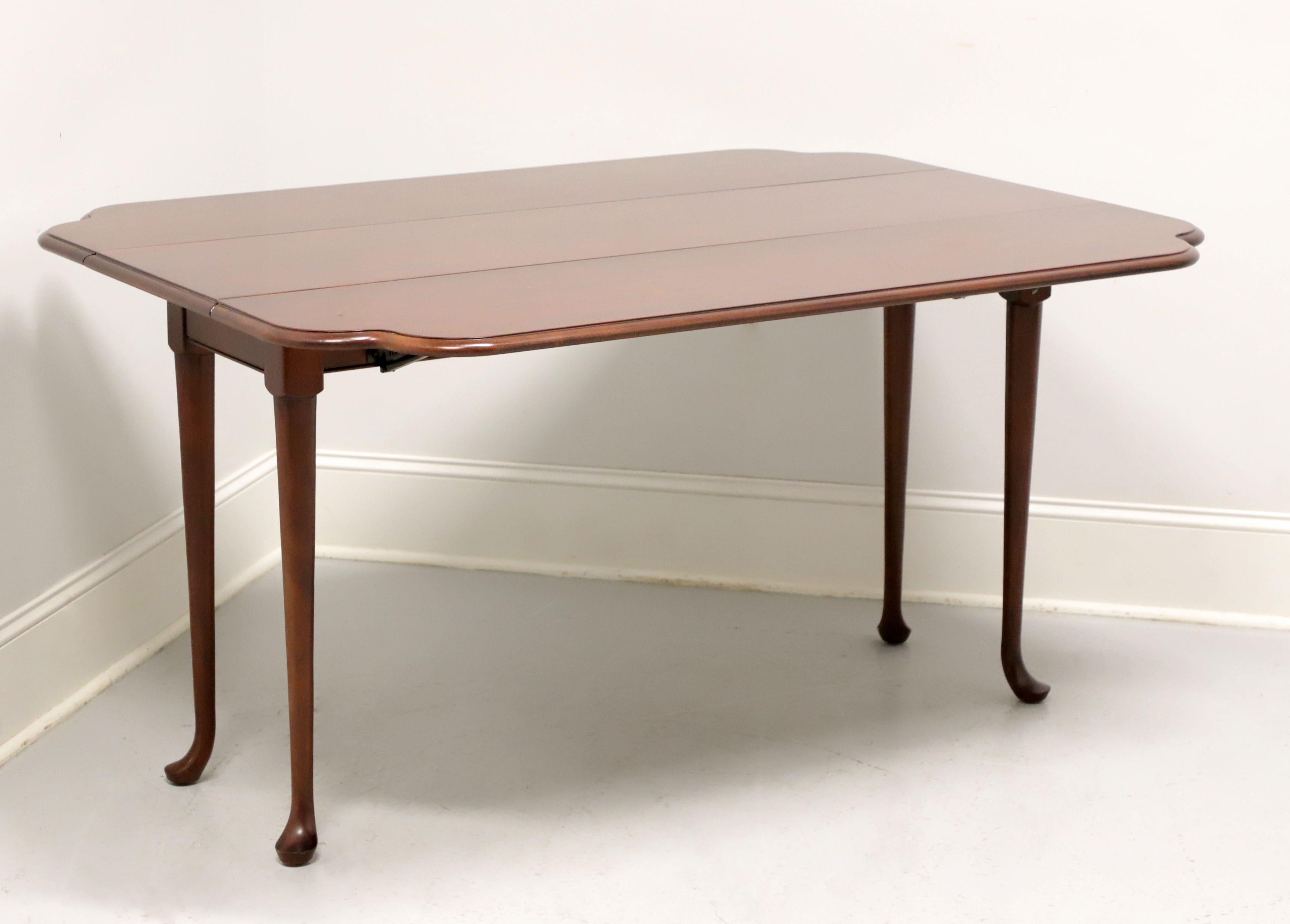 A Georgian style drop-leaf console sofa table by Drexel, from their Carleton Collection. Solid cherry with bevel edge top, clipped corners to drop leaves, slightly curved legs and pad feet. Features two drop leaves that can be raised for additional
