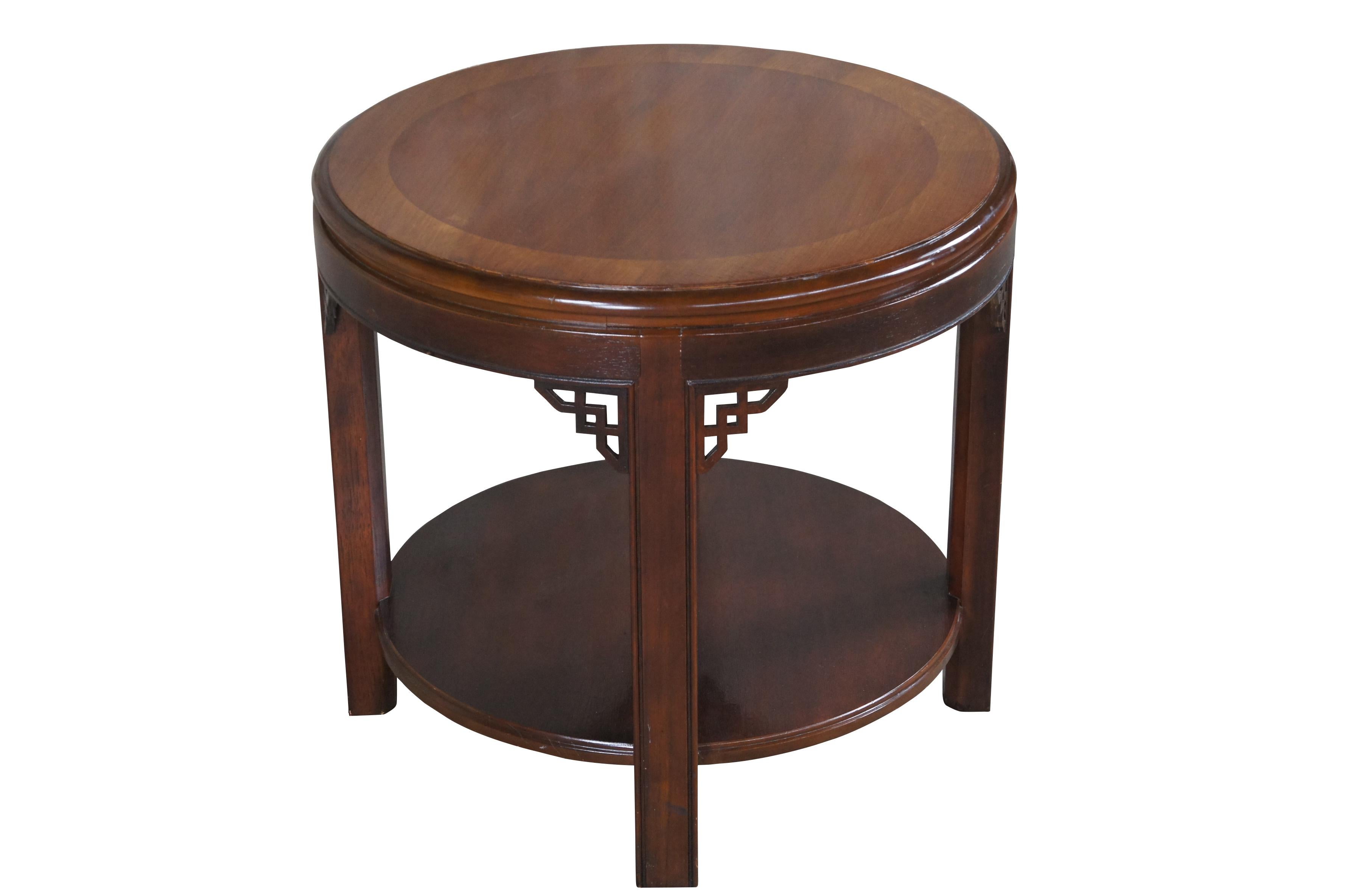 Vintage Drexel Heritage side accent table.  Made of mahogany featuring round form with two tiers, Chippendale styling and fretwork.  Circa 1986.

Dimensions:
24