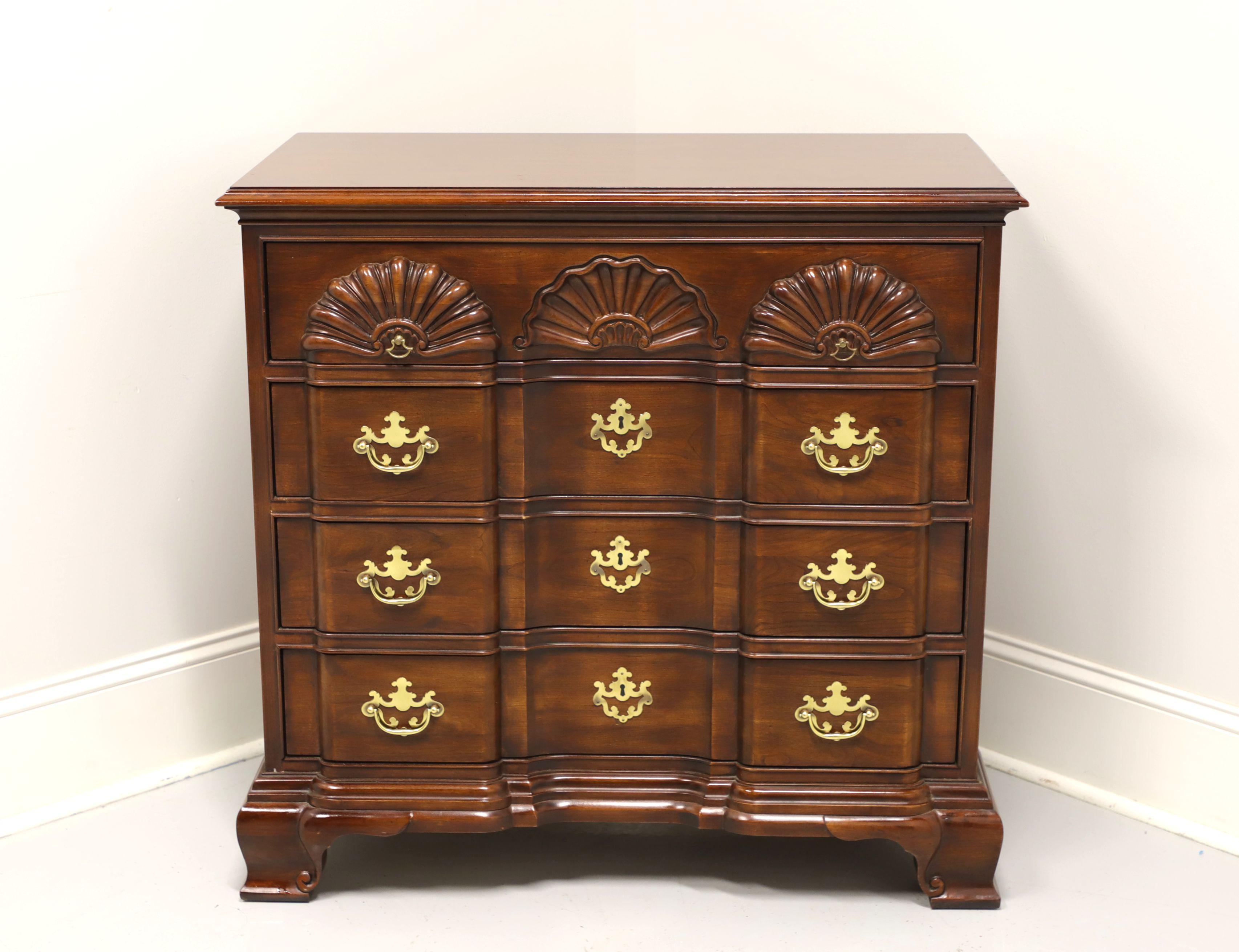 A Chippendale Goddard style block front bachelor chest by Drexel. Solid cherry with brass hardware, block front, shell carvings to top drawer and ogee bracket feet. Features four drawers of dovetail construction with three lower having faux keyhole