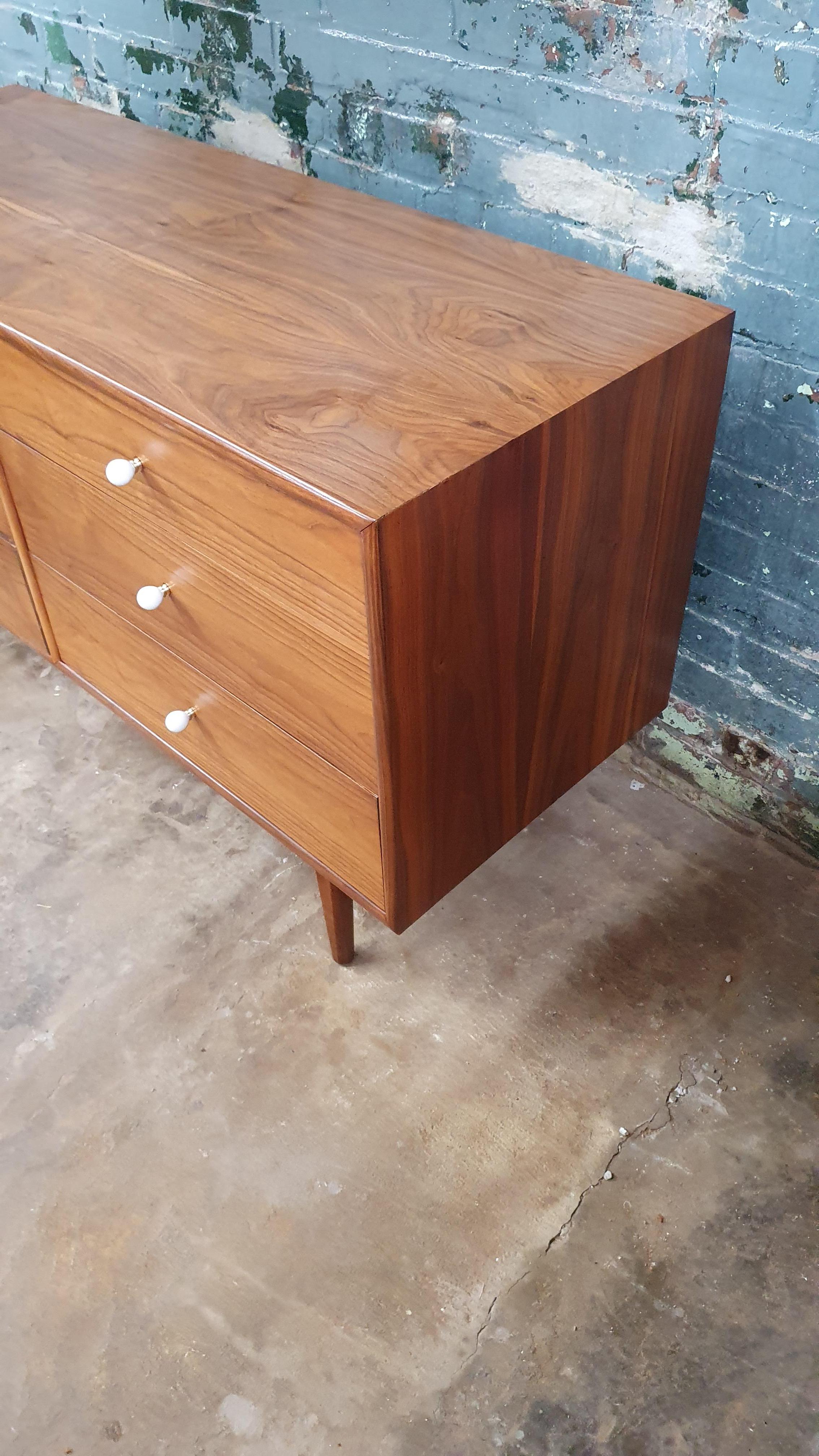 This Drexel Declaration 6-Drawer Dresser is a mid-century modern piece of furniture designed by Kipp Stewart and Stewart MacDougall for the Drexel Furniture Company in the 1950s. The dresser is a classic example of mid-century modern design,