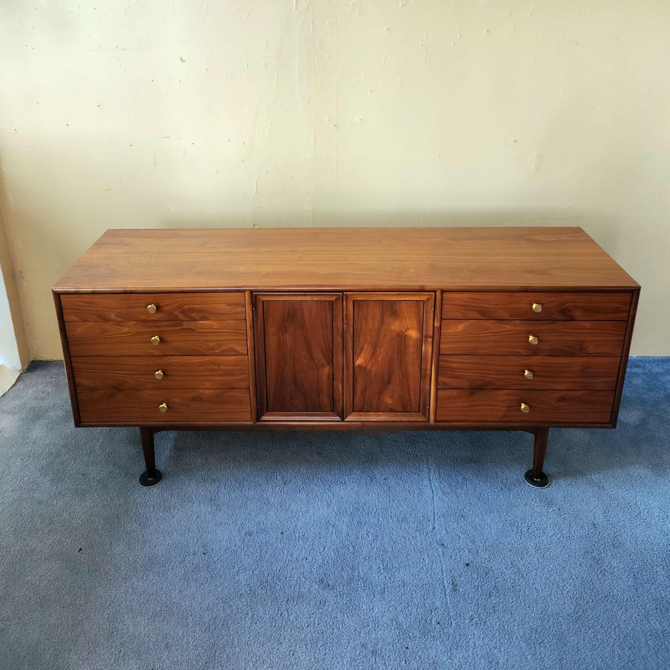 This gorgeous Mid-Century Modern eleven drawer dresser was designed by Kipp Stewart and Stewart MacDougall for Drexel’s Declaration Collection, circa 1960’s. Featuring a solid, beautifully grained walnut wood case and frame. This dresser was