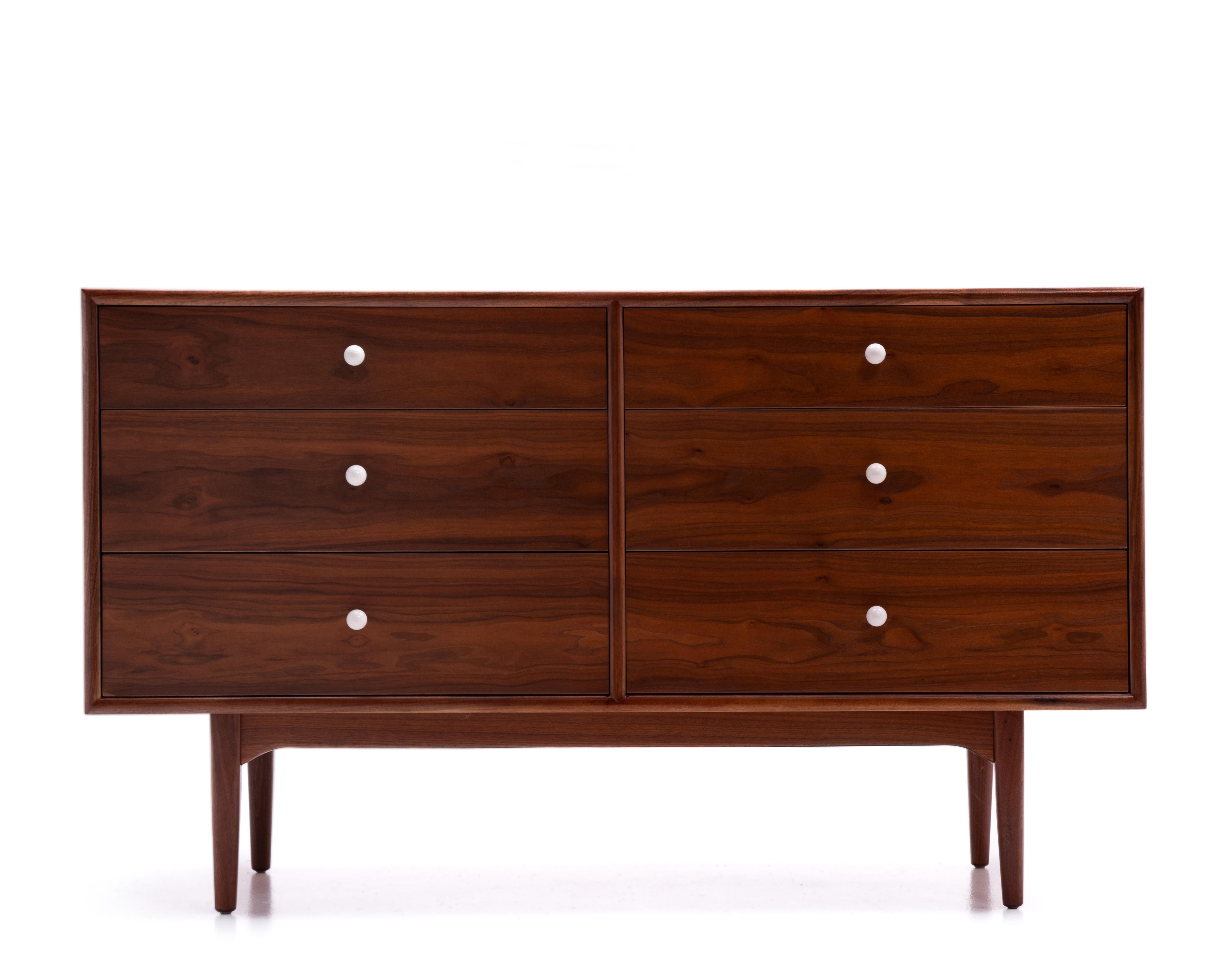 A Kipp Stewart & Stewart MacDougall 6 Drawer Lowboy Dresser for Drexel Declaration. Featuring six book matched drawers with porcelain and brass knobs over a stretcher base with nicely proportioned walnut tapered legs. Excellent joinery and very well