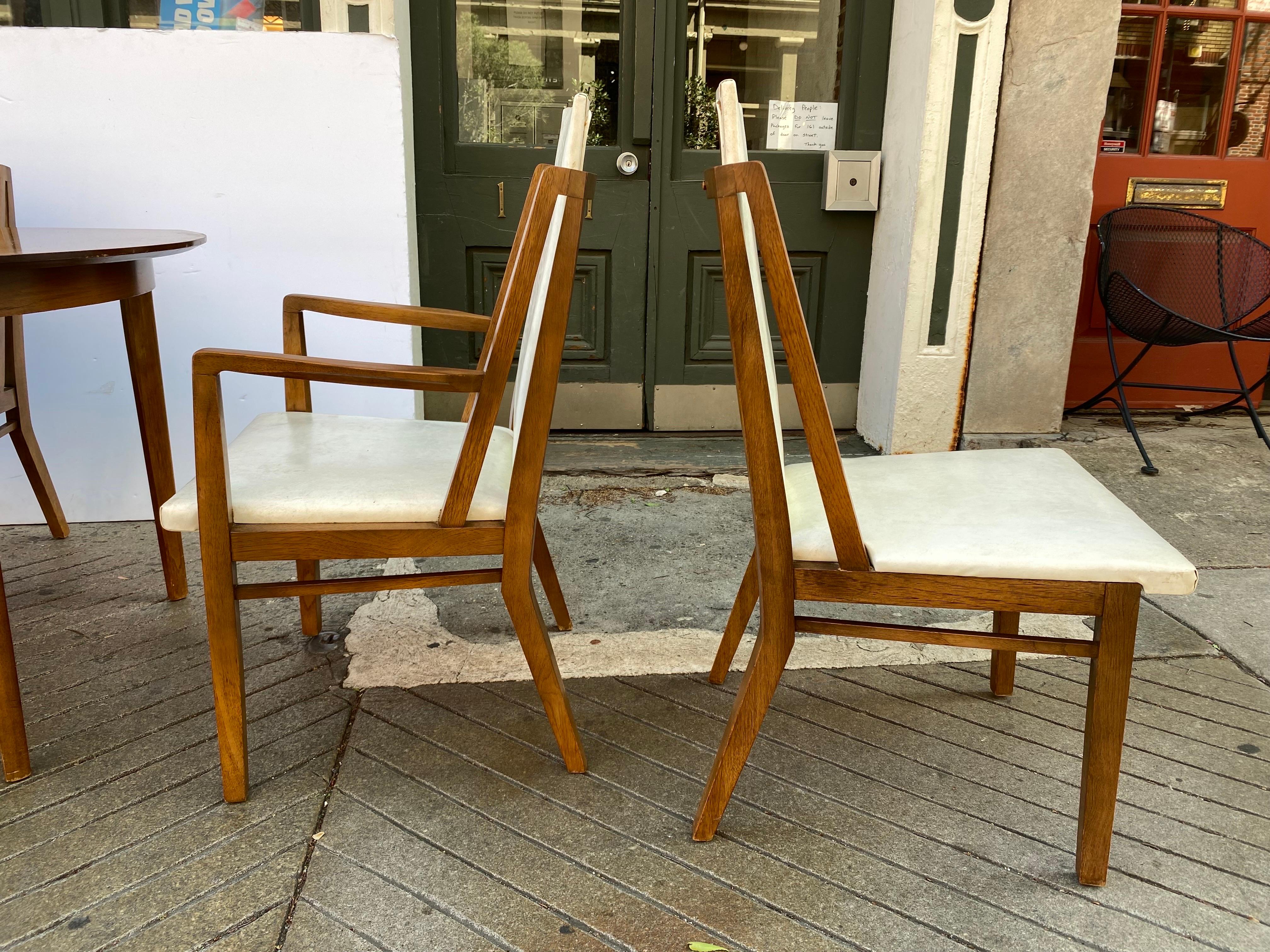 Drexel Design for living dining room set. Table with 2 leaves and 2 Armed Chairs and 4 armless chairs. Set is all original and in very nice shape. Table is slightly Boat-shaped. Banded edge. Table measures 60 x40 when closed. Two 18