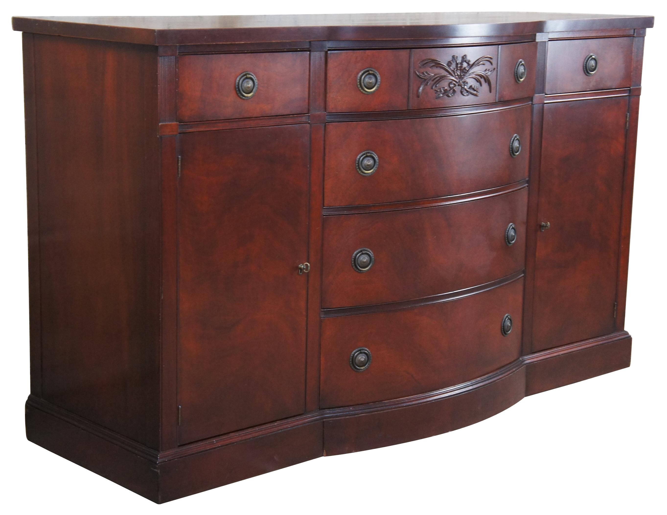 Vintage Drexel Duncan Phyfe Style bowfront server, circa 1940s. Made of genuine mahogany featuring six dovetailed drawers flanked by outer cupboard storage. Upper central drawer has a neoclassical carved design. Outer drawer drawers include dividers