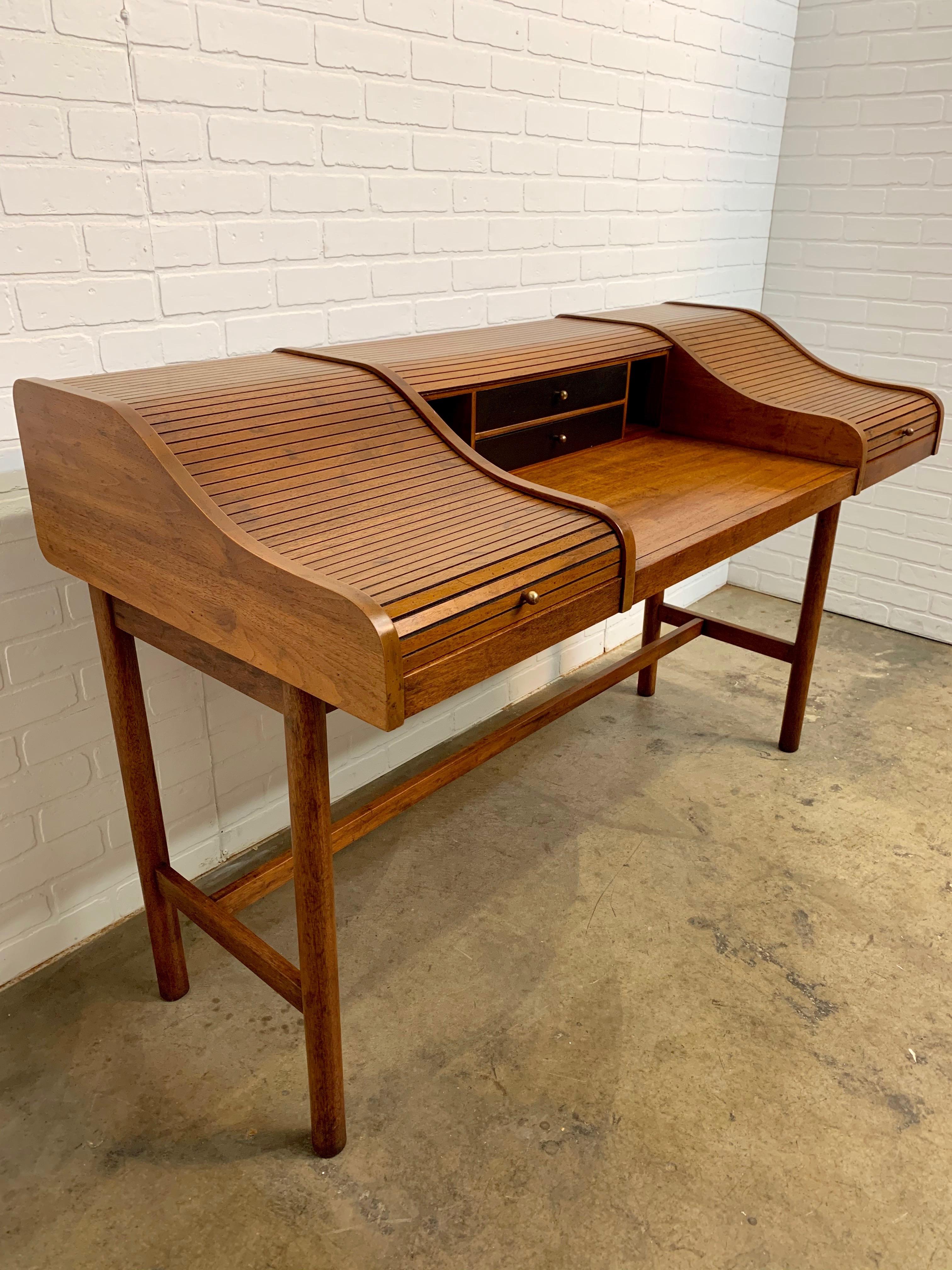 Beautiful modernist desk with two separate tambour sections and center work space and ebonized interior drawer fronts 
attributed to Edward Wormely.