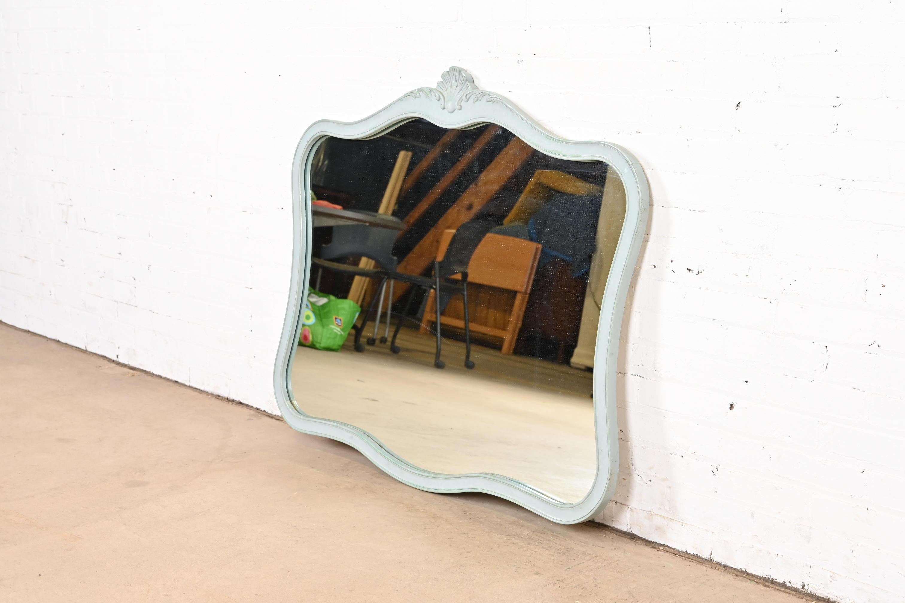 A stylish French Provincial Louis XV style framed wall mirror

By Drexel

USA, Circa 1960s

Carved walnut frame in original baby blue painted finish, with mirrored glass.

Measures: 45