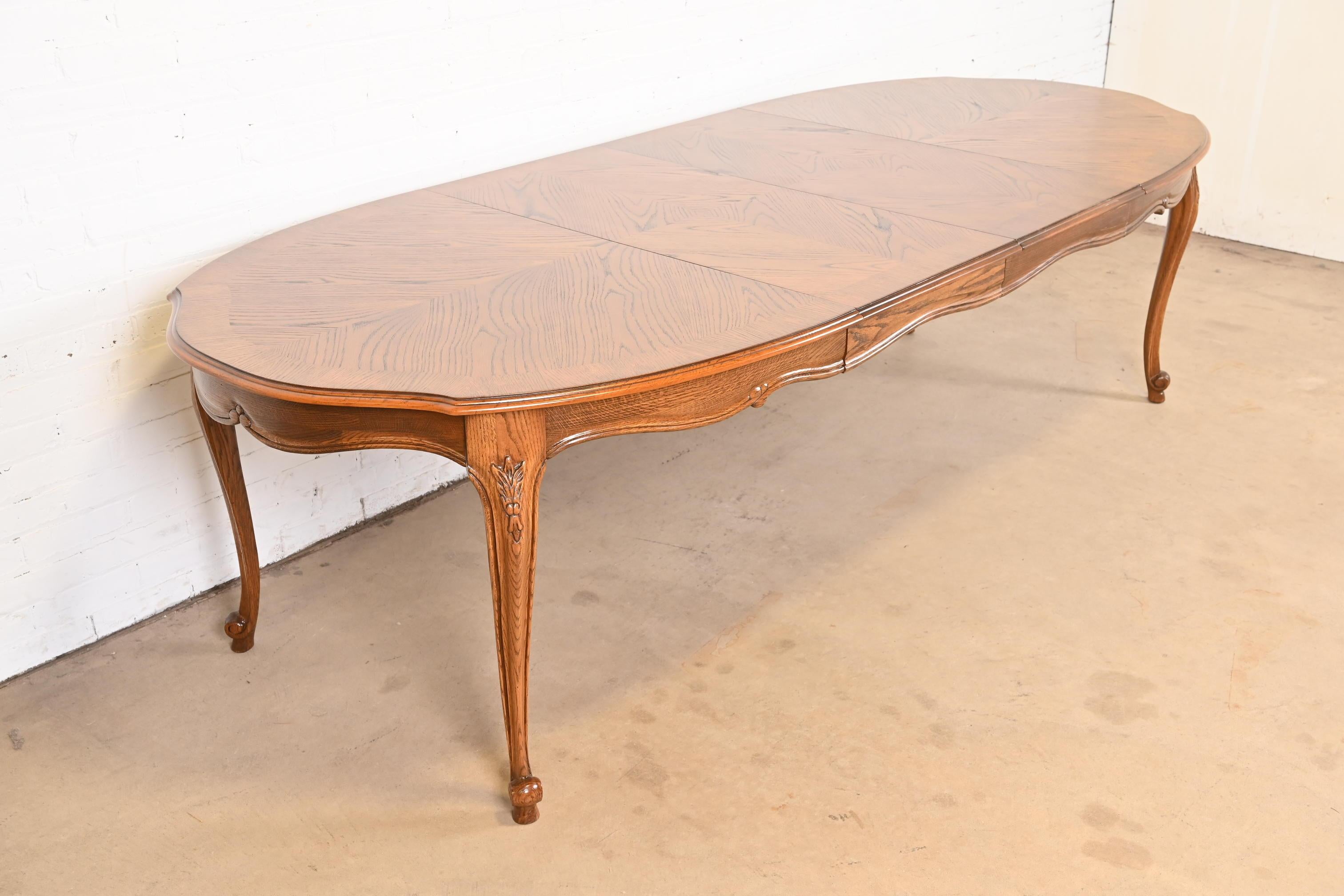 An exceptional French Provincial Louis XV style extension dining table

By Drexel

USA, Circa 1960s

Carved oak, with gorgeous book-matched top and carved cabriole legs.

Measures: 66
