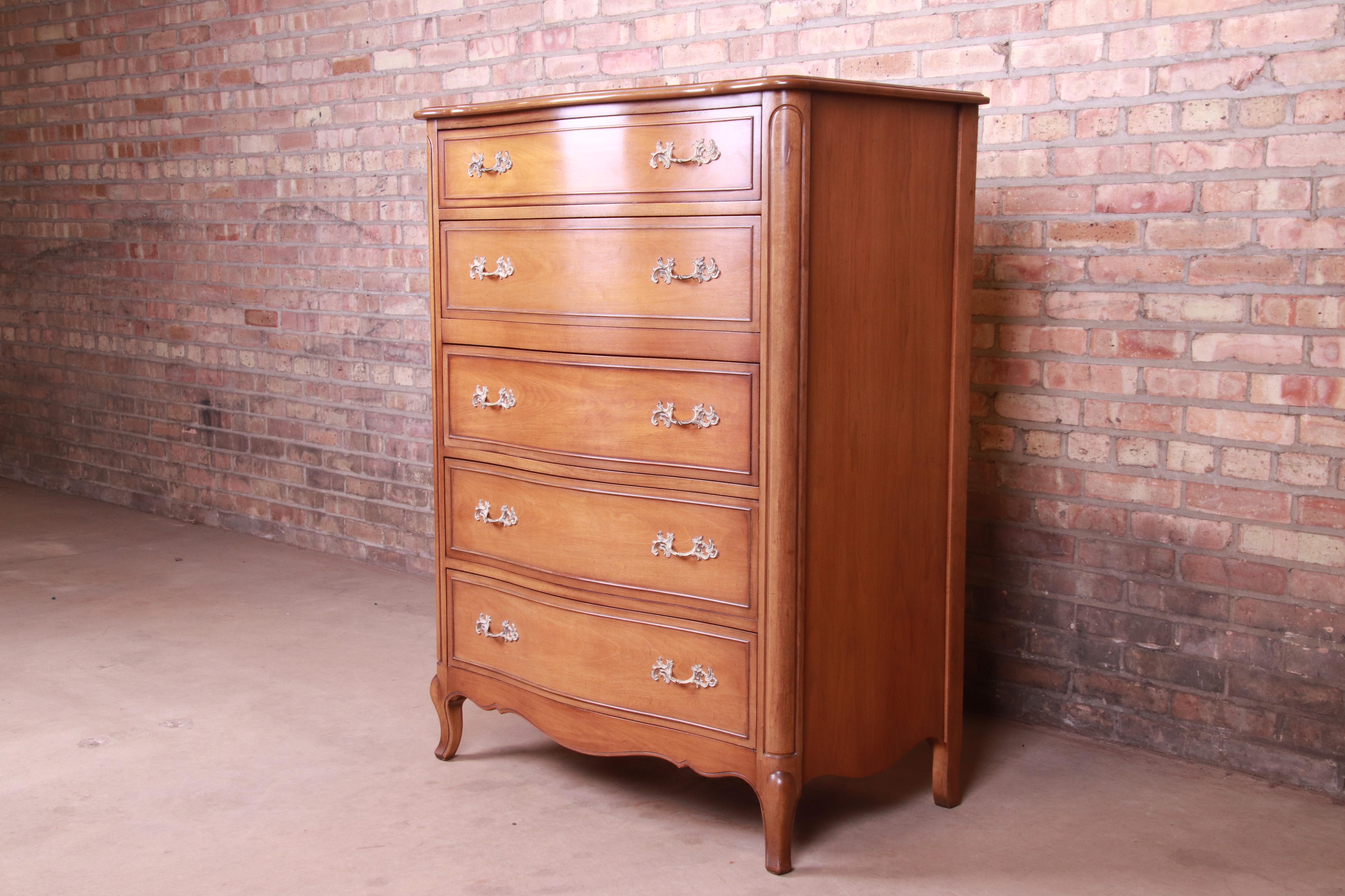 A gorgeous French Provincial Louis XV style five-drawer highboy dresser

By Drexel

USA, circa 1950s

Walnut, with original brass hardware.

Measures: 36.25