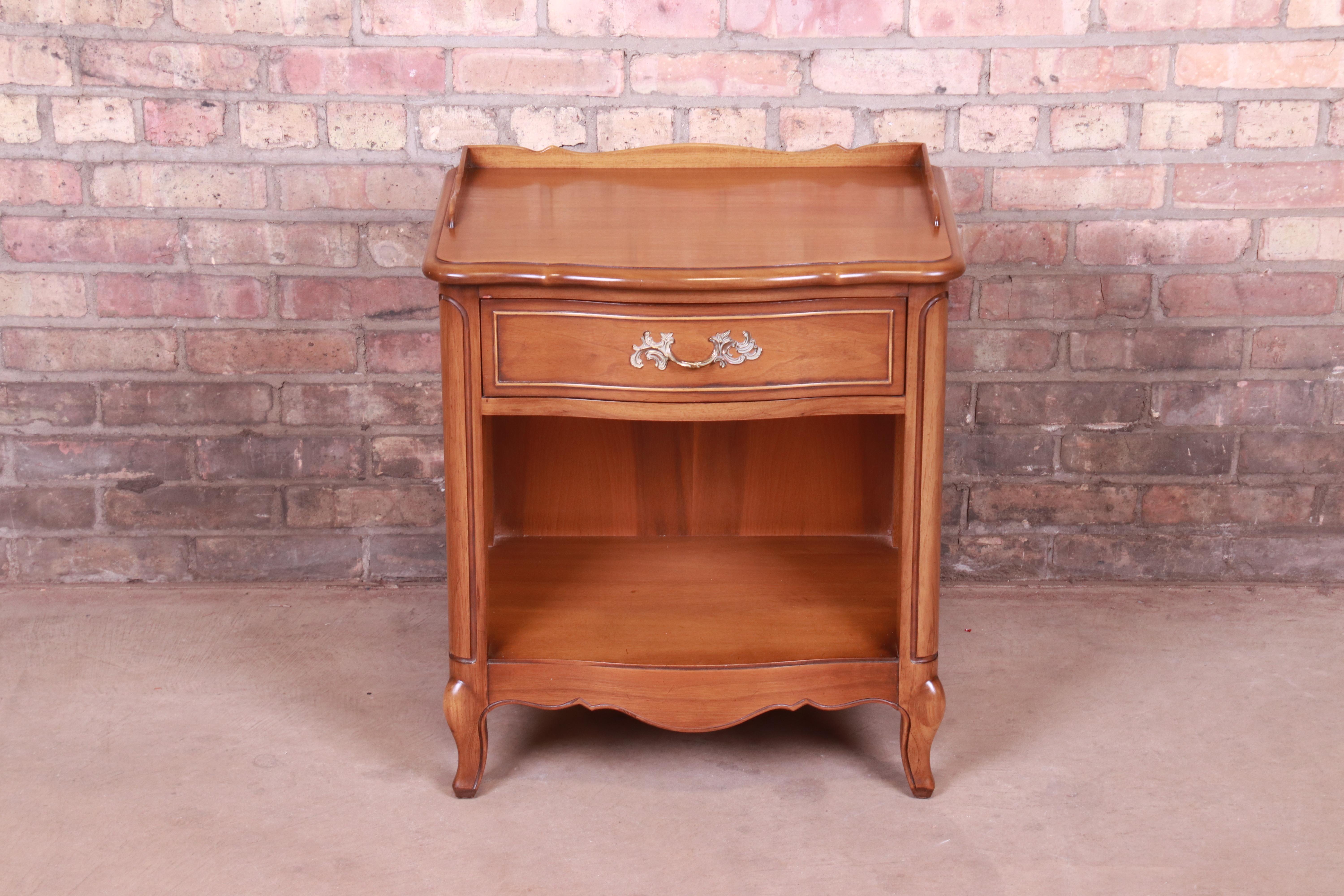 A gorgeous French Provincial Louis XV style nightstand

By Drexel

USA, circa 1950s

Walnut, with original brass hardware.

Measures: 22