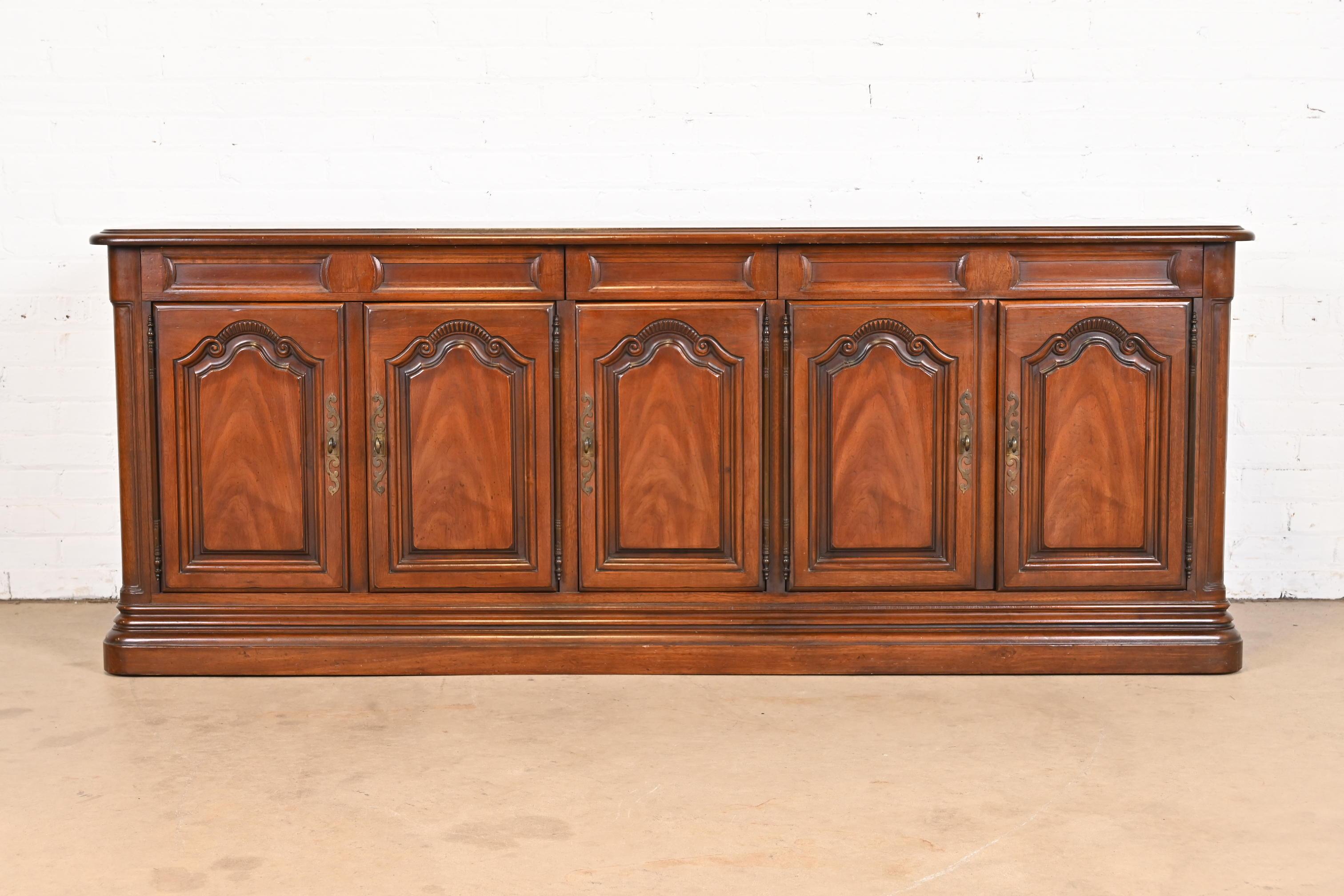 A gorgeous French Provincial Louis XV style sideboard, credenza, or bar cabinet

By Drexel

USA, Circa 1960s

Carved walnut, with original brass hardware.

Measures: 78