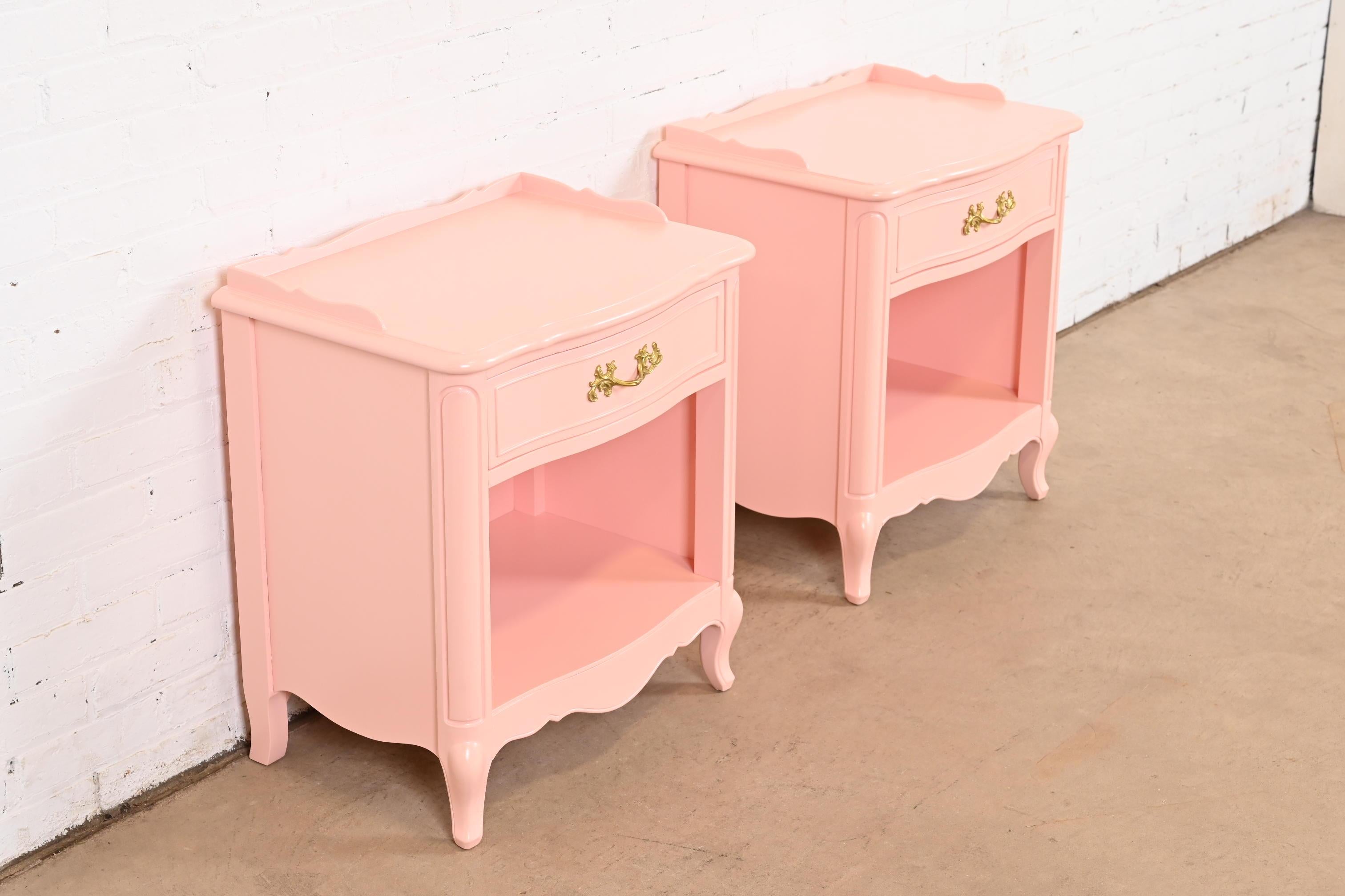 A gorgeous pair of French Provincial Louis XV style nightstands or end tables

By Drexel

USA, Circa 1960s

Pink lacquered cherry wood, with original brass hardware.

Measures: 22