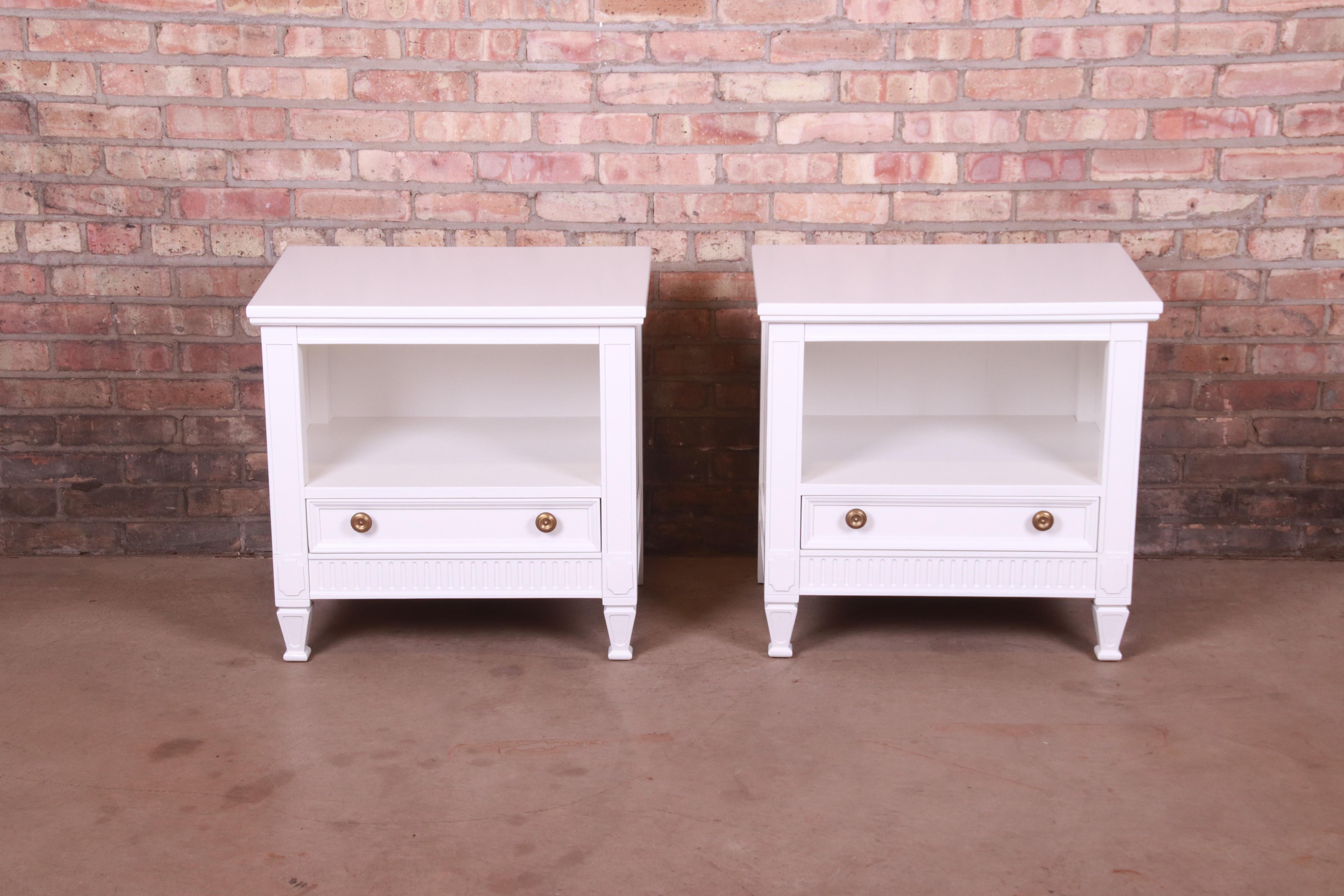 A gorgeous pair of mid-century French Regency Louis XVI style nightstands or end tables

By Drexel

USA, Circa 1950s

White lacquered walnut, with original brass hardware.

Measures: 24.63