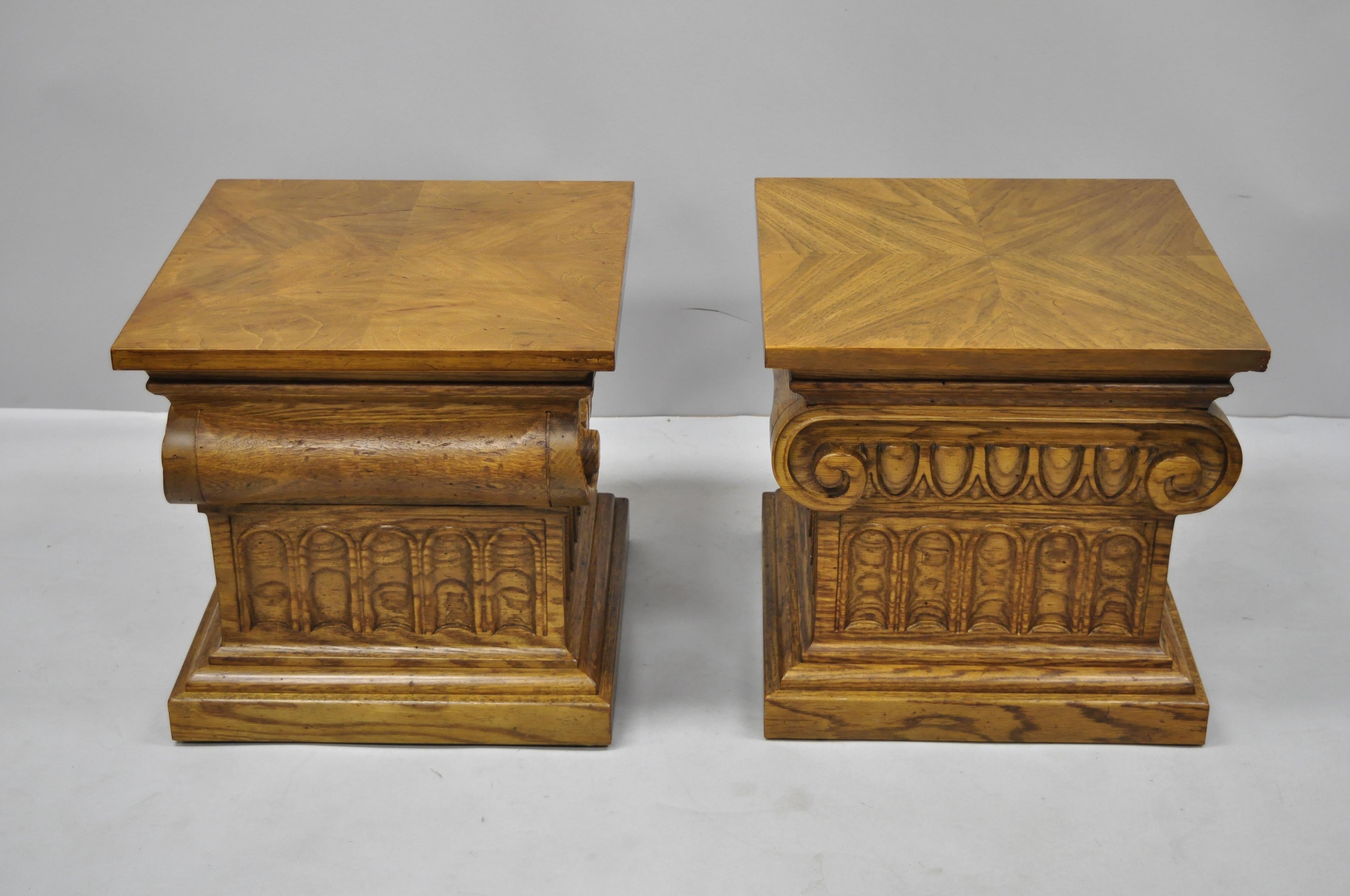 Drexel Furniture Guildhall pair of Corinthian column low pedestal stands. Items feature carved Corinthian column base, sunburst tops, beautiful wood grain, original stamp, and quality American craftsmanship, circa 1960s. Measurements: 17.5