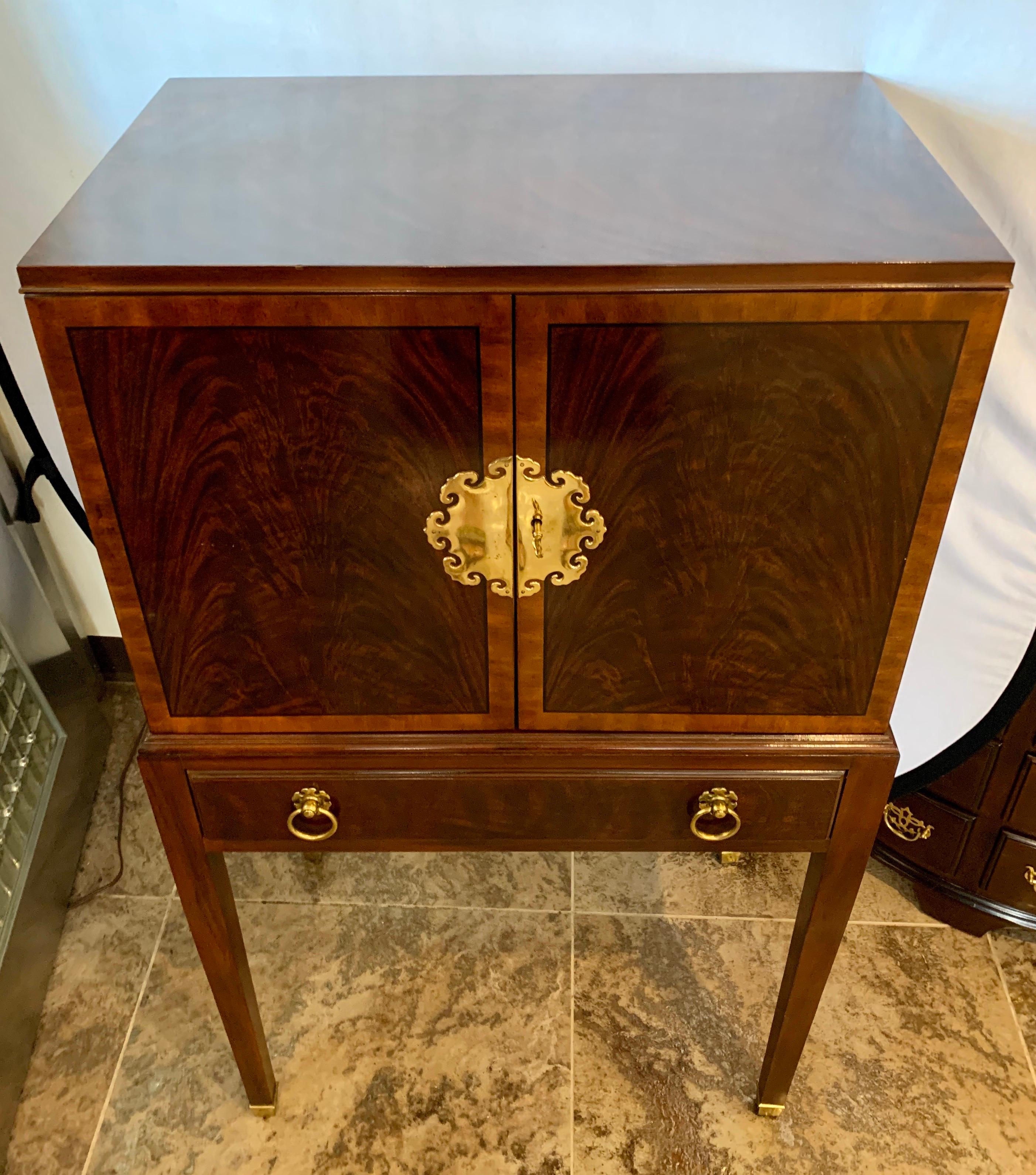 Gorgeous vintage Drexel furniture mahogany inlay silverware chest on stand. The top portion has two front doors that open to four felt lines drawers. The bottom portion has one-drawer. All original brass round drawer pulls. Doors have ornate