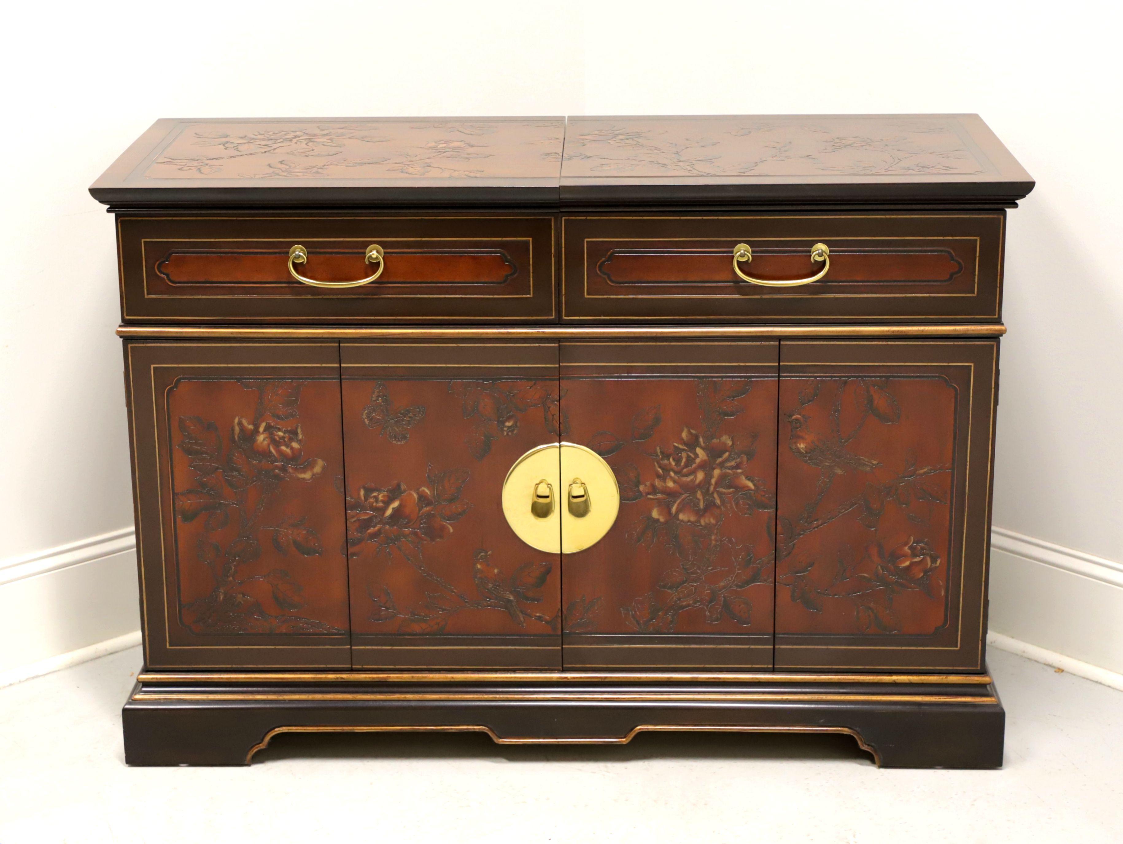 An Asian inspired server by Drexel Heritage. Highly polished hardwood & veneers with carved Chinoiserie scenes to top, sides & door fronts, brass hardware, hard composite surface under slide out banded top and bracket feet. Features the slide out