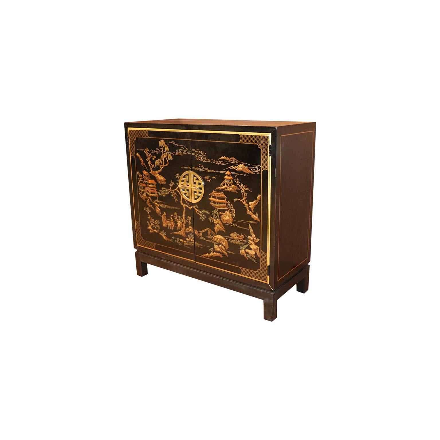 Gorgeous black lacquer, elegant Asian, chinoiserie style two- door cabinet, circa 1980s. This cabinet is part of the Et Cetera collection by Drexel. Features rectangular top, above double cabinet doors fitted with polished brass round Chinese style