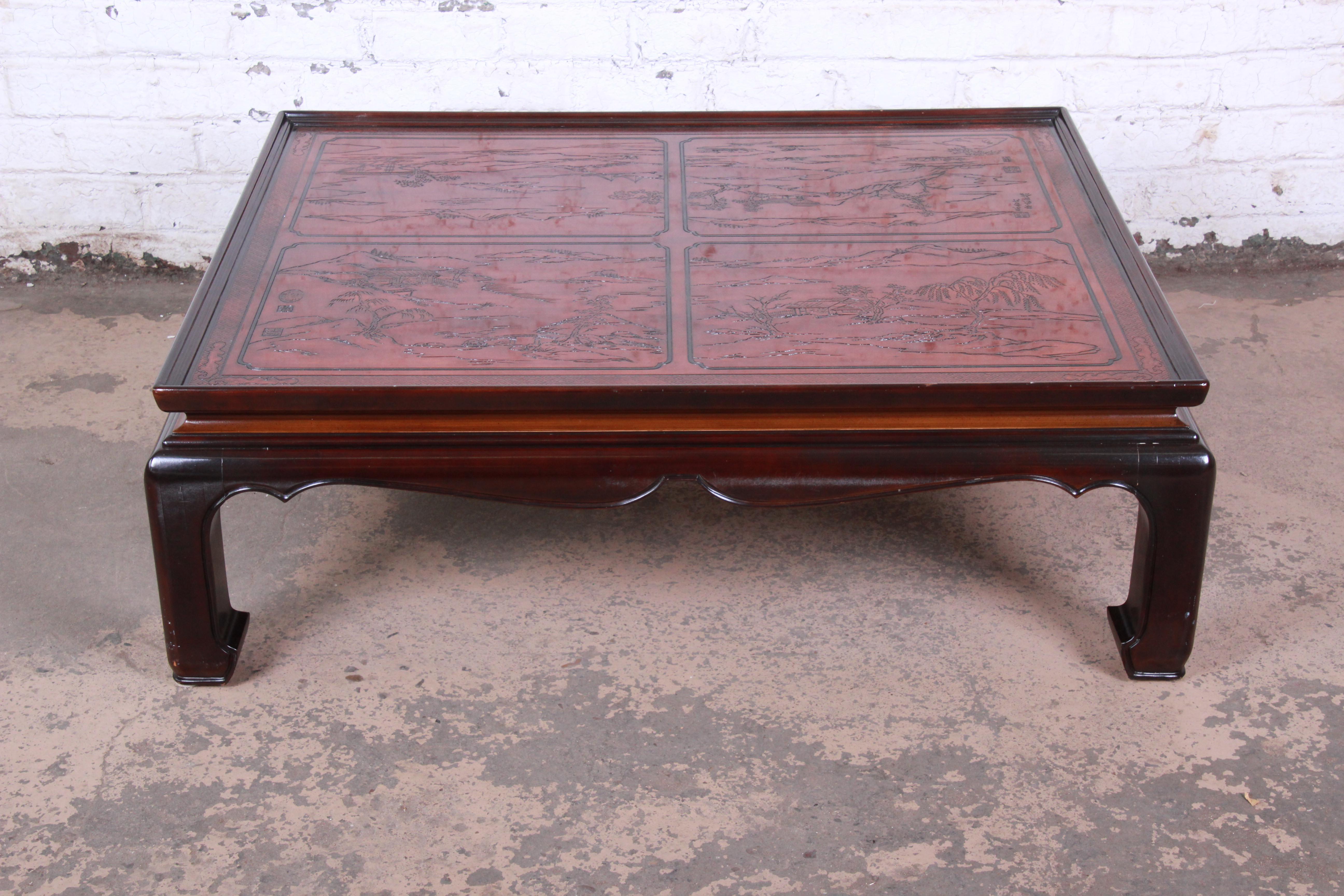 A gorgeous Hollywood Regency Chinoiserie coffee or cocktail table from the Conoisseur line by Drexel Heritage. The table features beautiful mahogany wood grain and unique carved Asian details with nature scenes. The table is in very good original