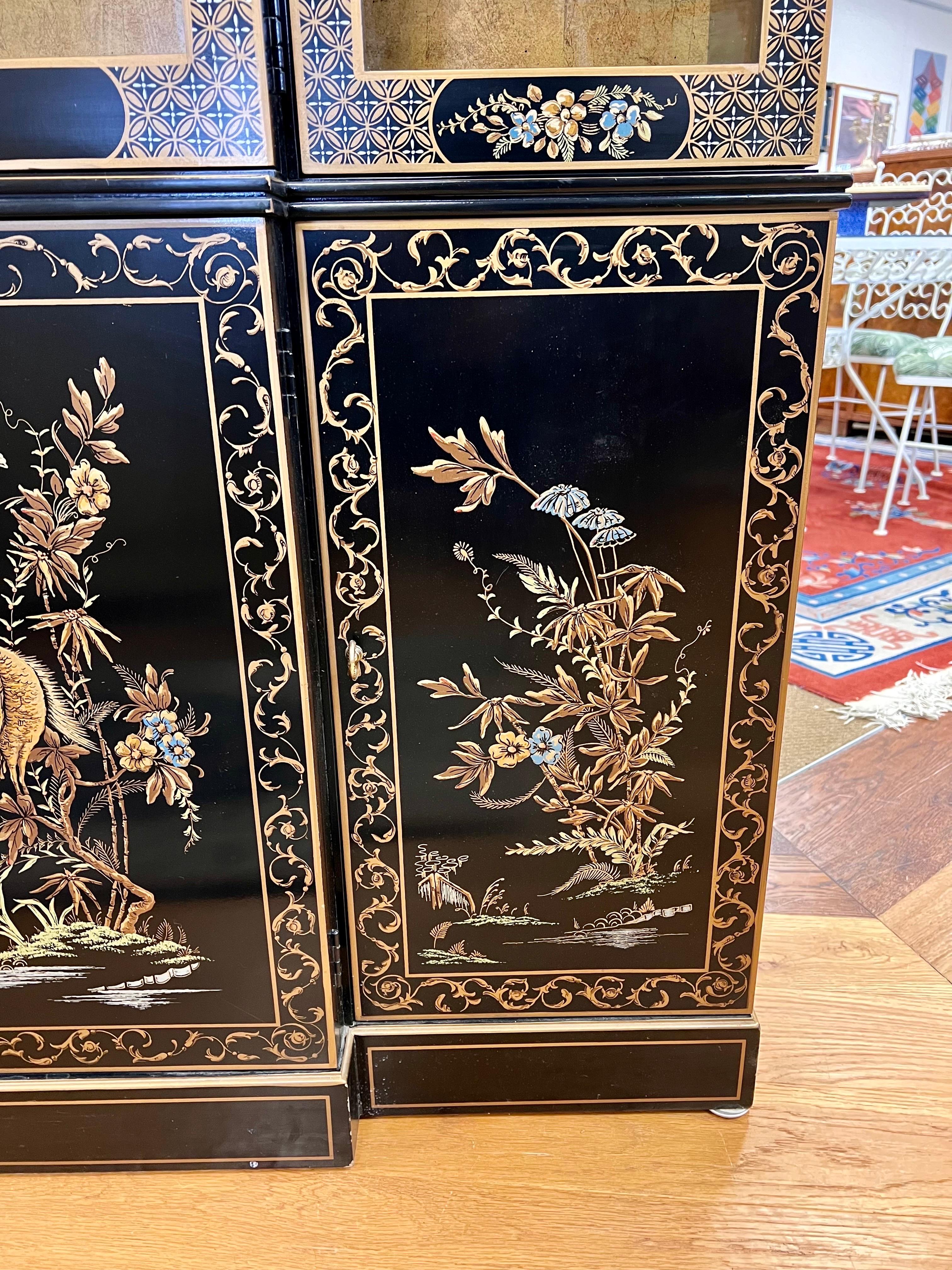 Stunning Drexel Et Cetera liine china cabinet circa 1978.  Features Chinoiserie japanned black lacquer hand painted motif with gold detail showing landscape of florals/flowers/animals/birds and butterfly.  The cabinet is fully electrified and comes