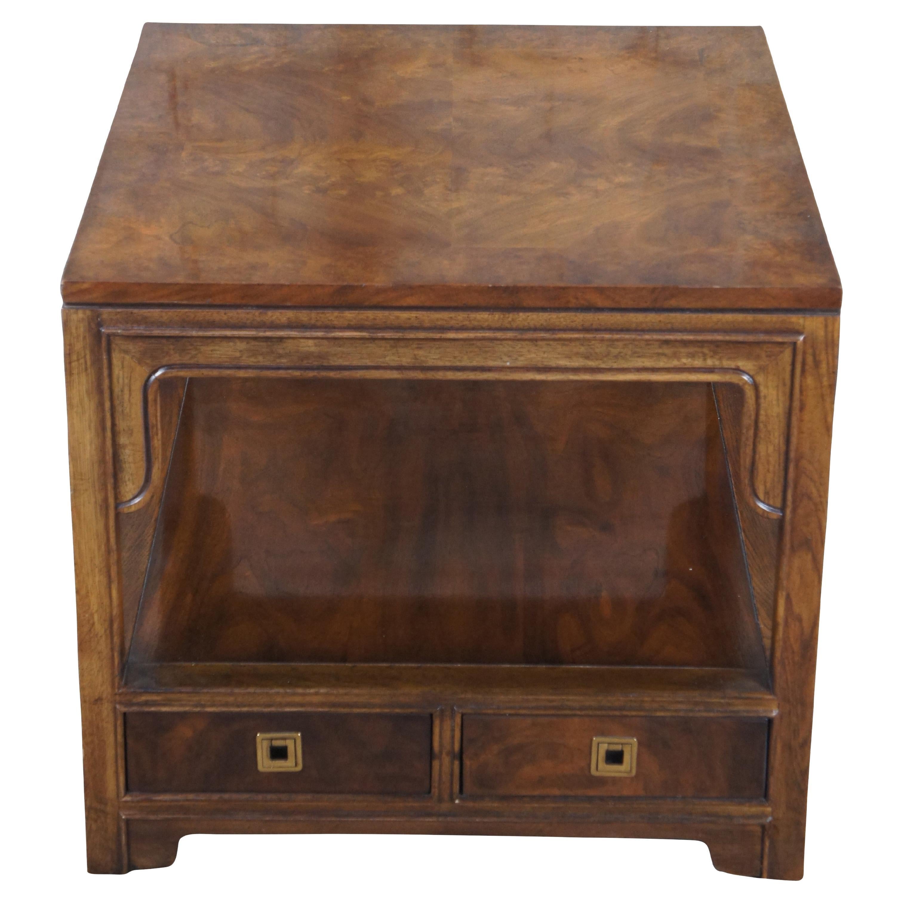 1980s Drexel Heritage Chinoiserie / Campaign style side table.  Features a square form walnut with matchbook burl and banded top.  The table showcases chinoiserie molding, a central shelf and two dovetailed drawers with inset brass hardware.  Marked
