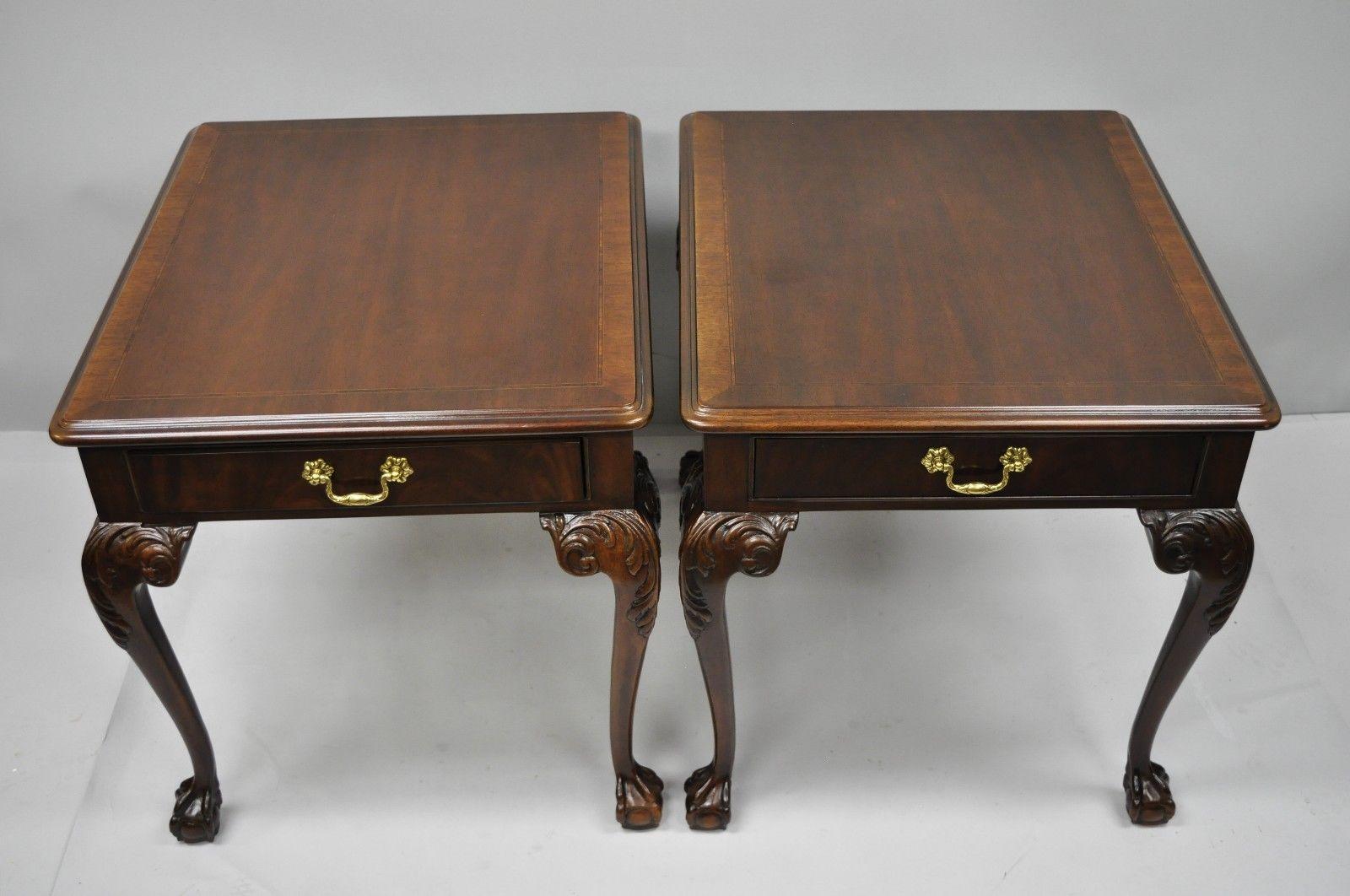 Pair of Drexel Heritage Chippendale style ball and claw mahogany end tables. Item features solid wood construction, beautiful wood grain, serial number #074-326, nicely carved details, finished back, one dovetailed drawer, cabriole legs, solid brass