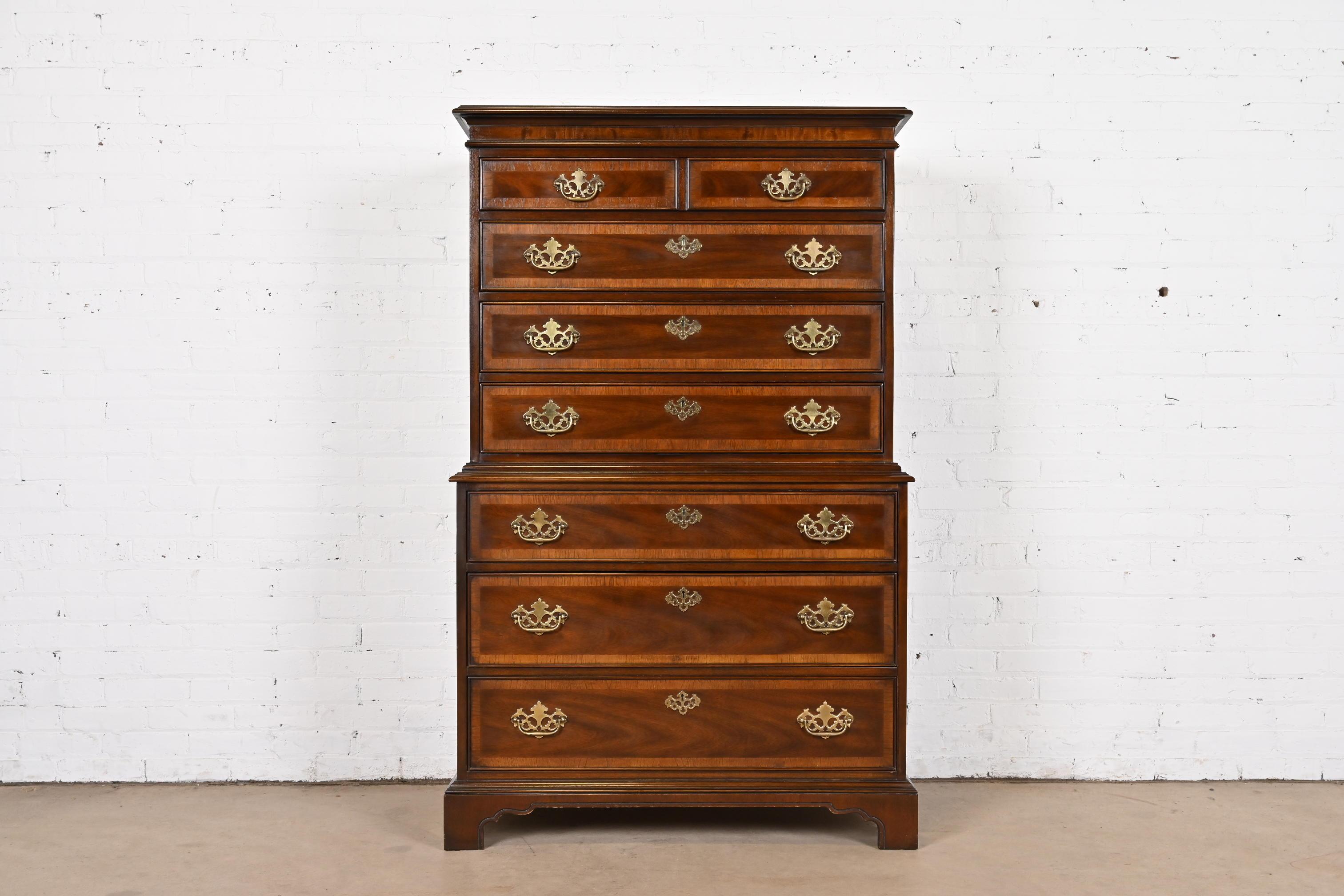 A gorgeous Georgian or Chippendale style seven-drawer highboy dresser

By Drexel Heritage

USA, Circa 1980s

Beautiful banded mahogany, with original brass hardware.

Measures: 39.5