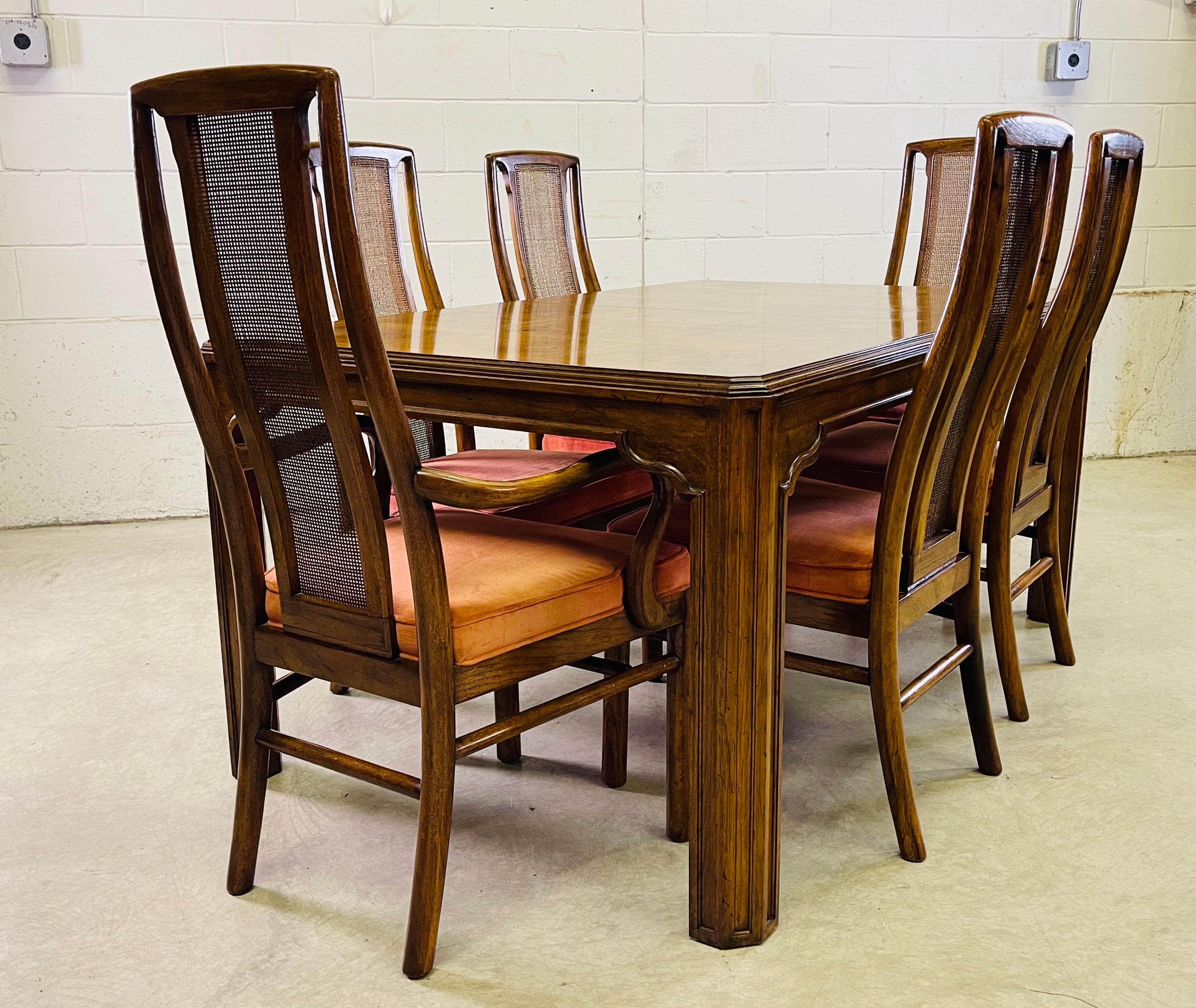 Vintage Drexel Heritage Sketchbook dining table with six chairs. The chairs are curved with a cane back and has two arm chairs. The table is a block style burlwood. The table comes with two additional boards at 20”L each. The table fully open is