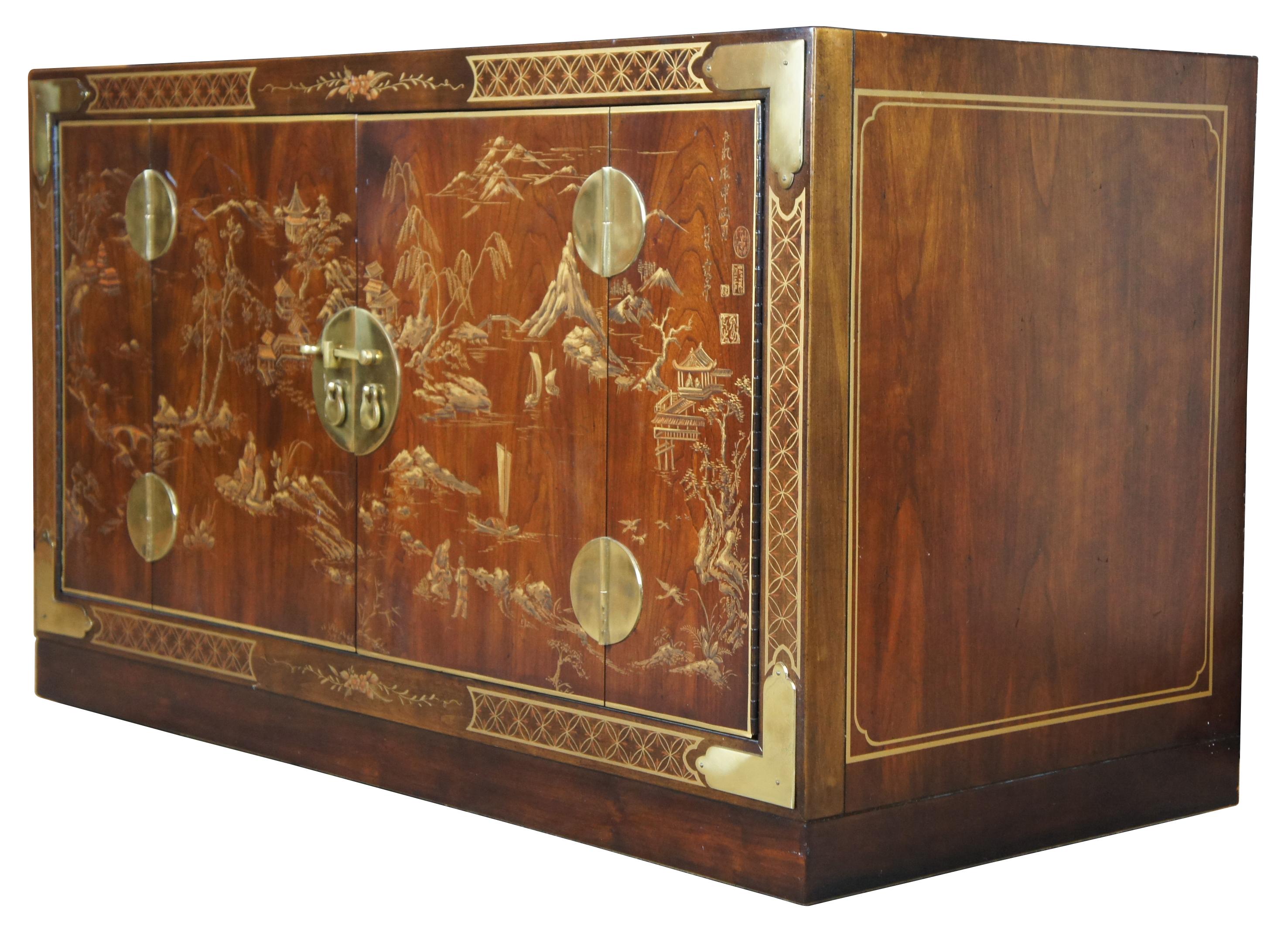 Rare 1977 Drexel Heritage Et Cetera chinoiserie console cabinet. Made of a rosewood veneer with rectangular form featuring brass accents, central medallion and hand painted gold details showing Asian landscape of figures, pagodas, water, mountains,