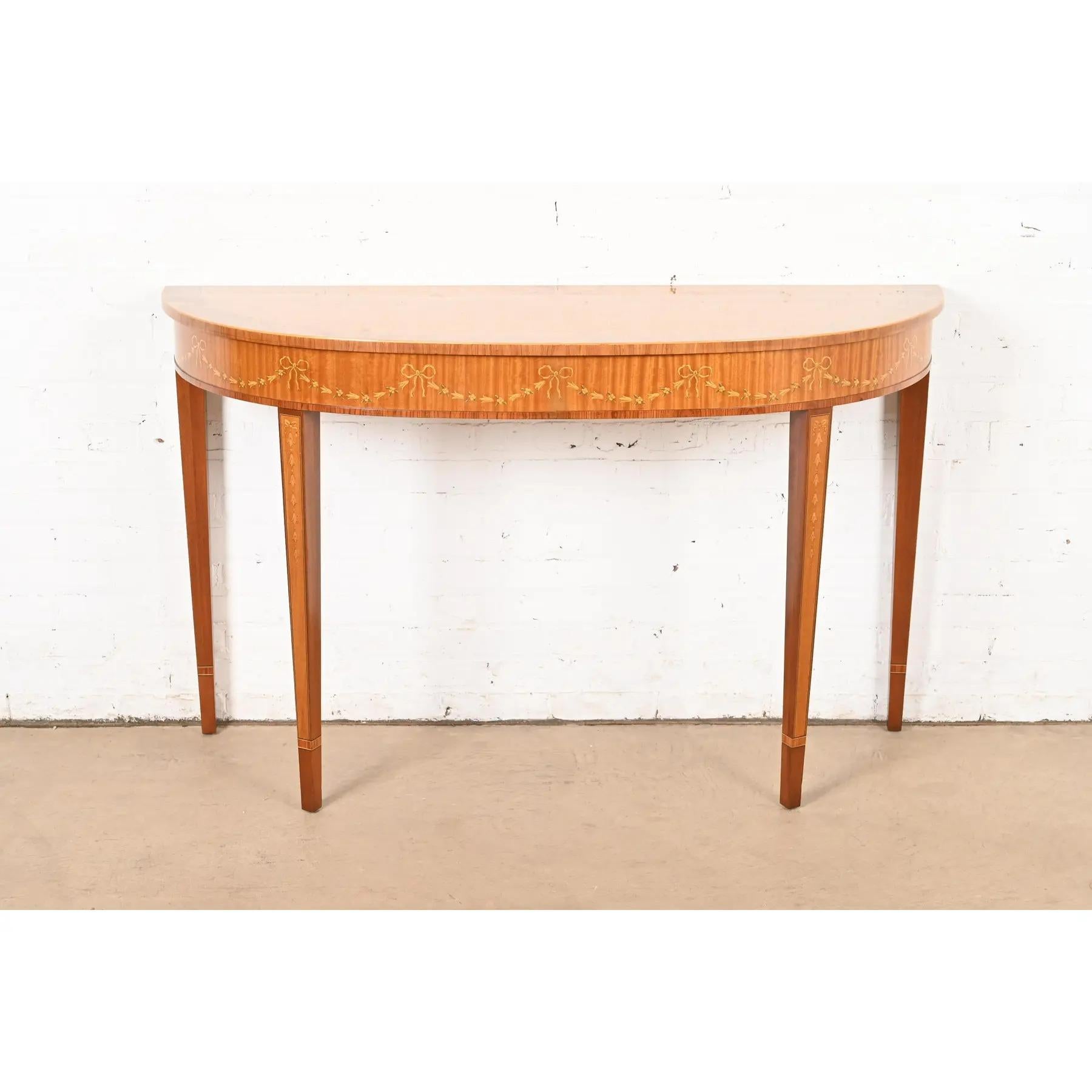 A gorgeous Federal or Hepplewhite style console or entry table

By Drexel Heritage

USA, Circa 1980s

Banded and inlaid satinwood, with paint decorated details. 

Measures: 56