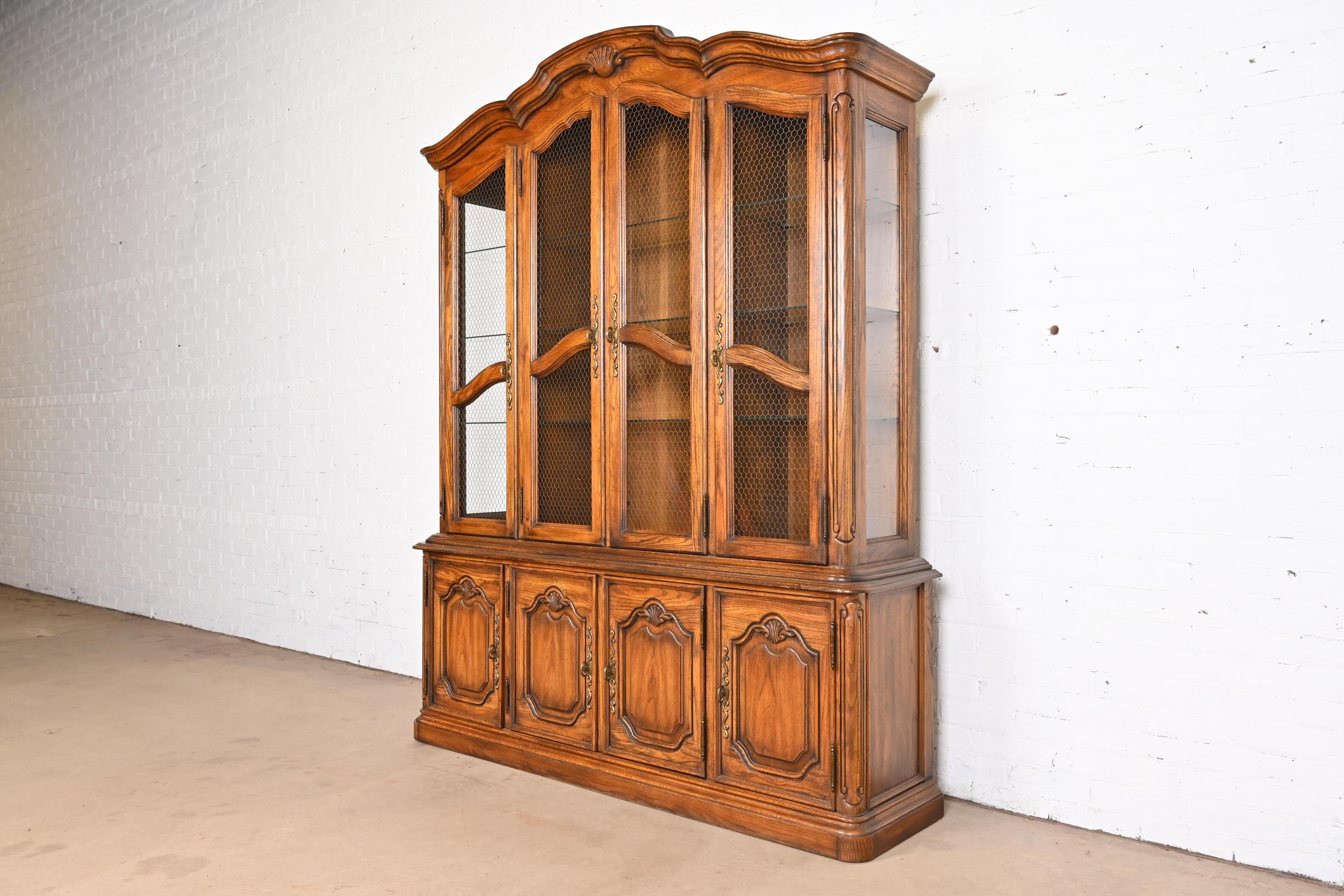 American Drexel Heritage French Provincial Carved Oak Lighted Breakfront Bookcase Cabinet For Sale