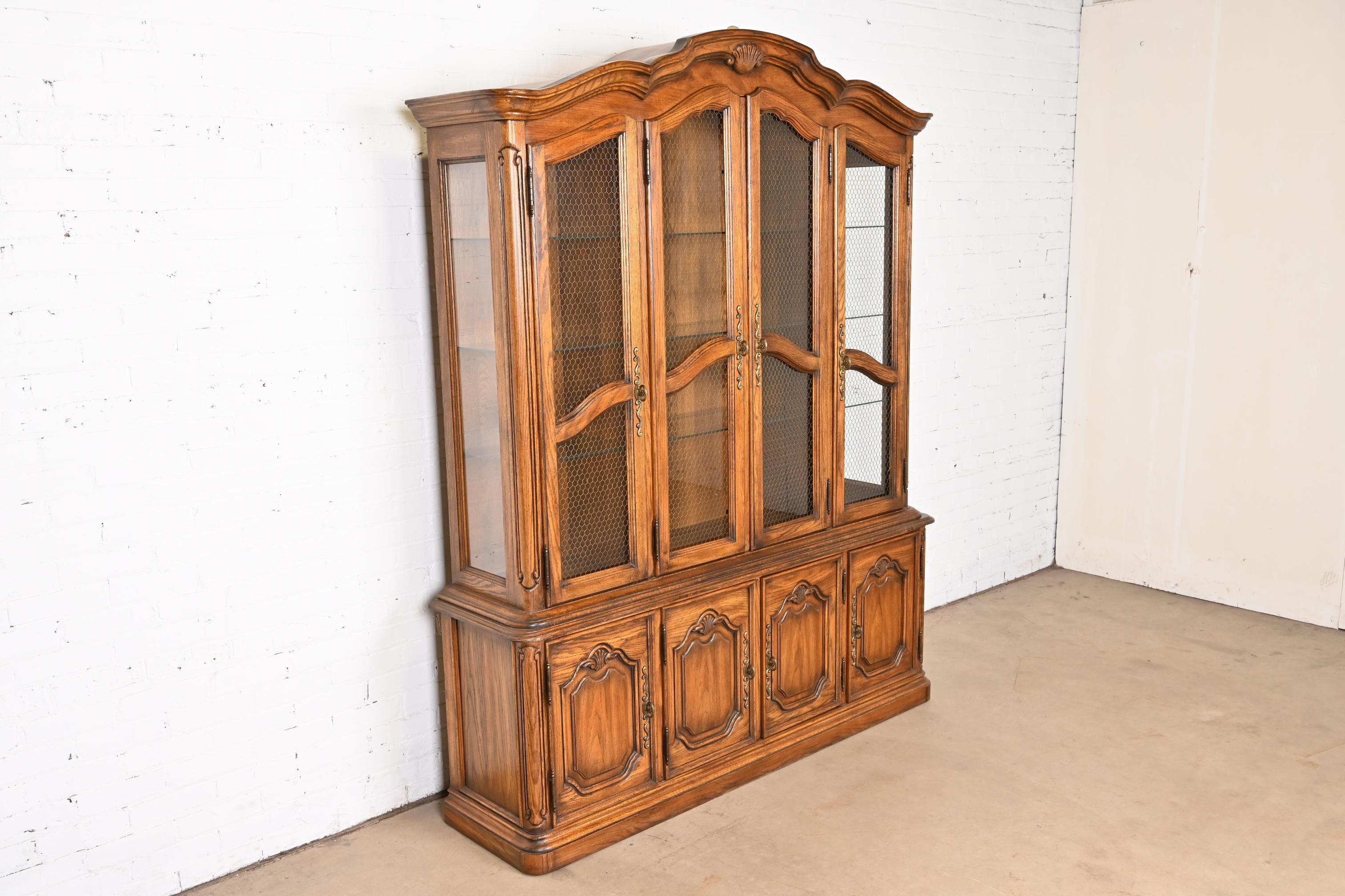 Brass Drexel Heritage French Provincial Carved Oak Lighted Breakfront Bookcase Cabinet For Sale
